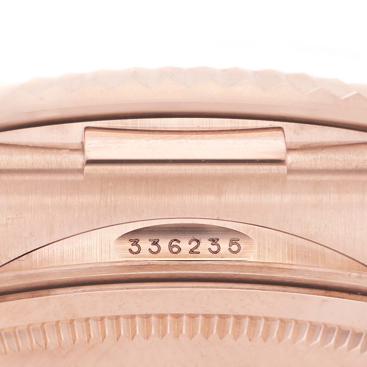 The image shows a close-up of the caseback and serial number of a Rolex Daytona 336235 Men's Rose Gold Brown Dial.