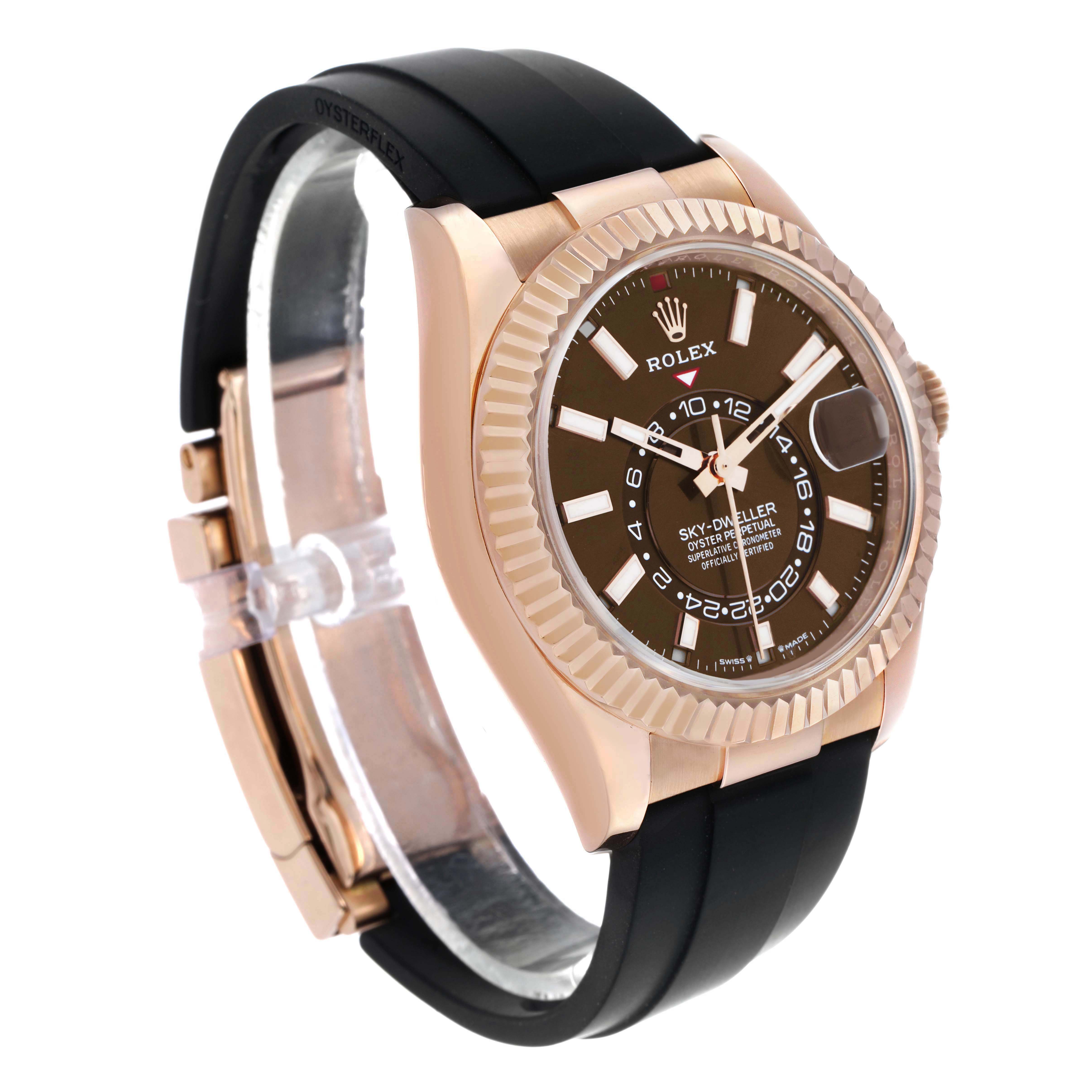 The image shows a Rolex Sky-Dweller watch at a side angle, highlighting the face, bezel, strap, and clasp.