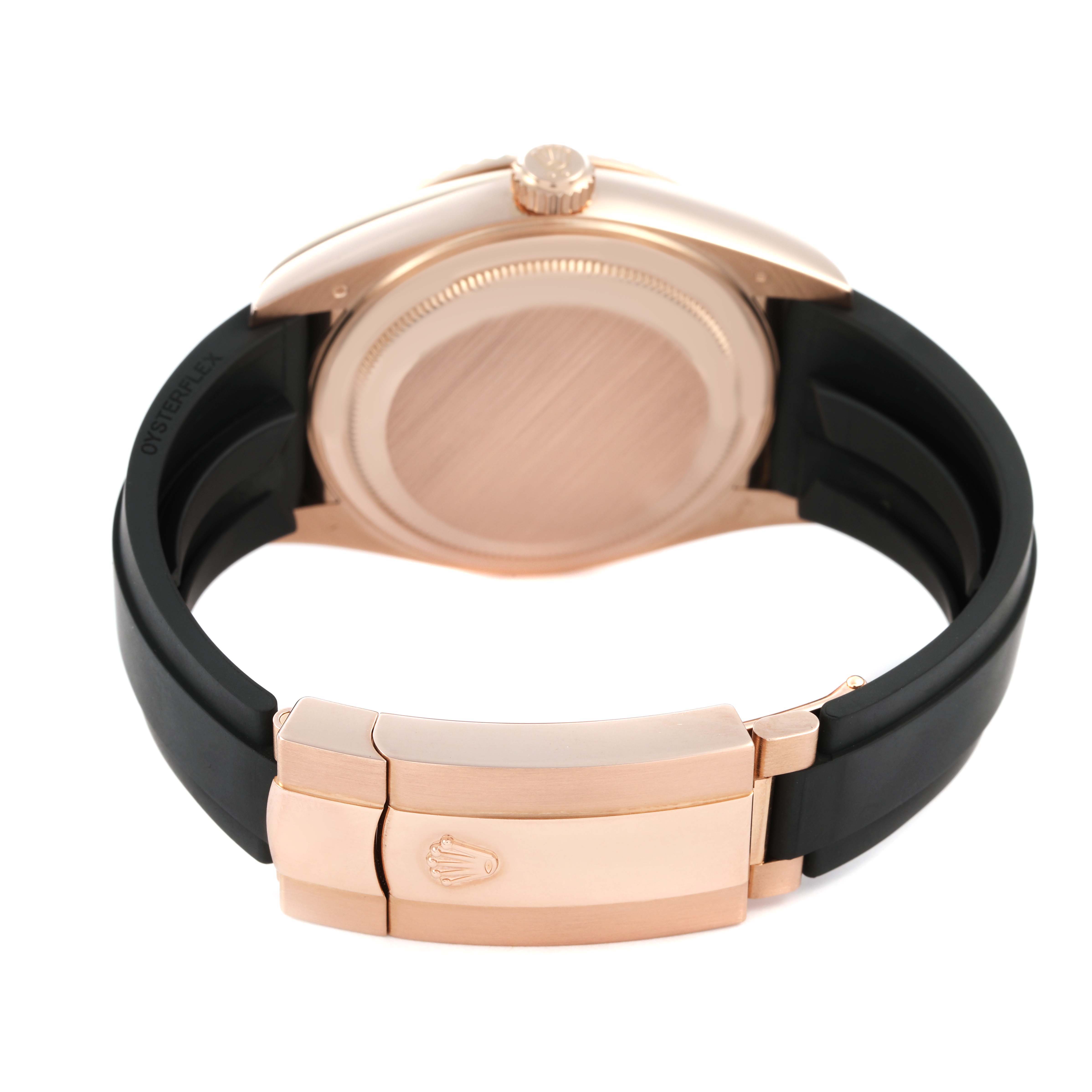 The image shows the back of a Rolex Sky-Dweller 326235 Men's Rose Gold Grey Dial, highlighting the case back, crown, and clasp with a black strap.