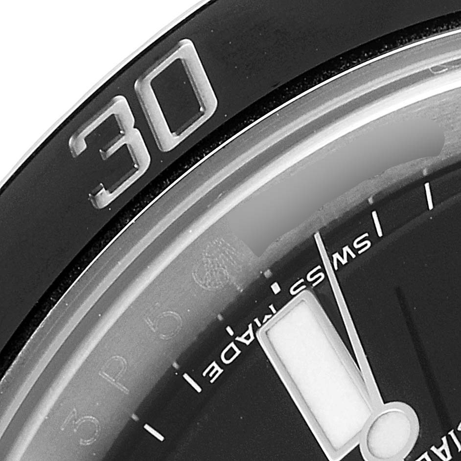 This close-up of a Rolex Submariner 116610LN Men
s Stainless Steel Black Dial 116610LN Men
s Stainless Steel Black Dial shows the bezel with the "30" marker and a portion of the dial with the "SWISS MADE" text.