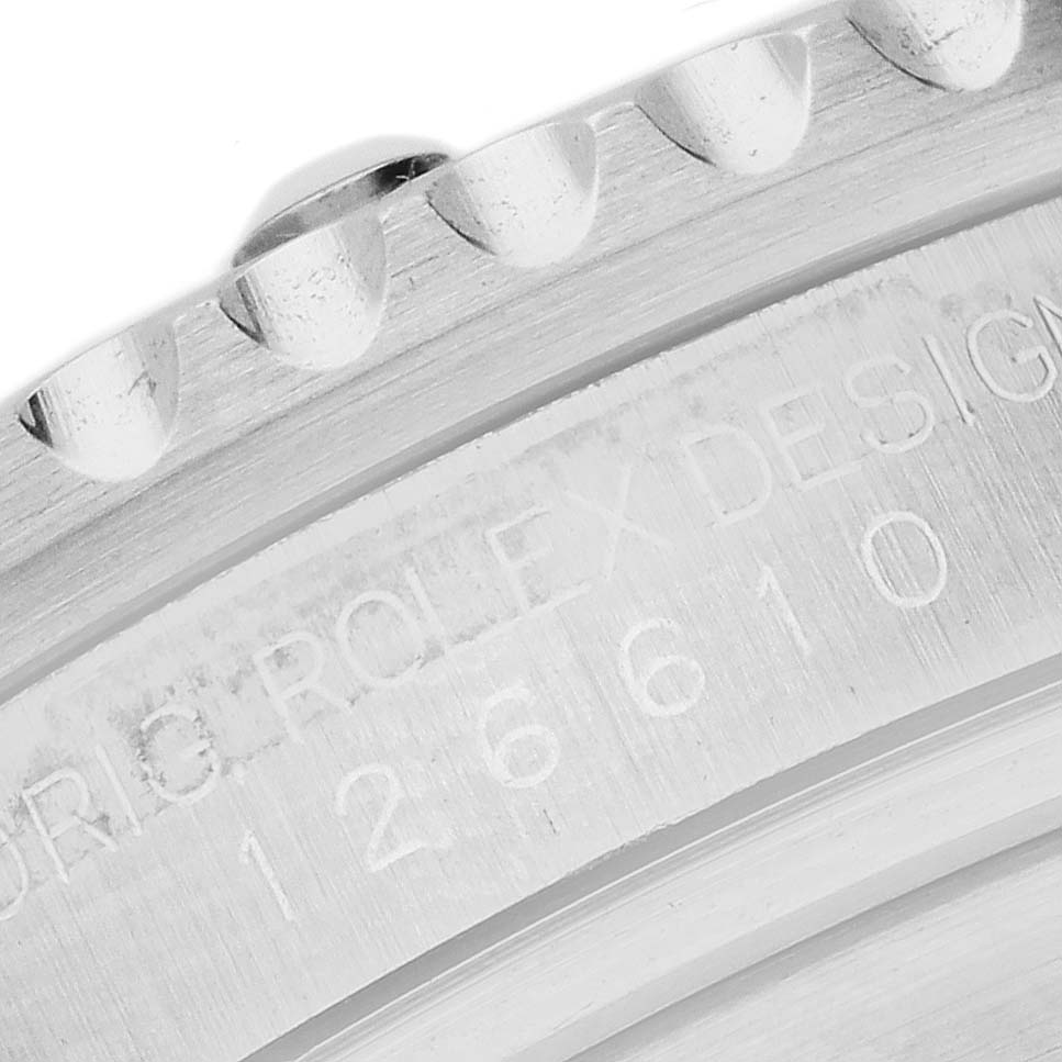 The image shows a close-up of the engraved bezel and case side of a Rolex Submariner 126610 Men's Stainless Steel Black Dial watch.