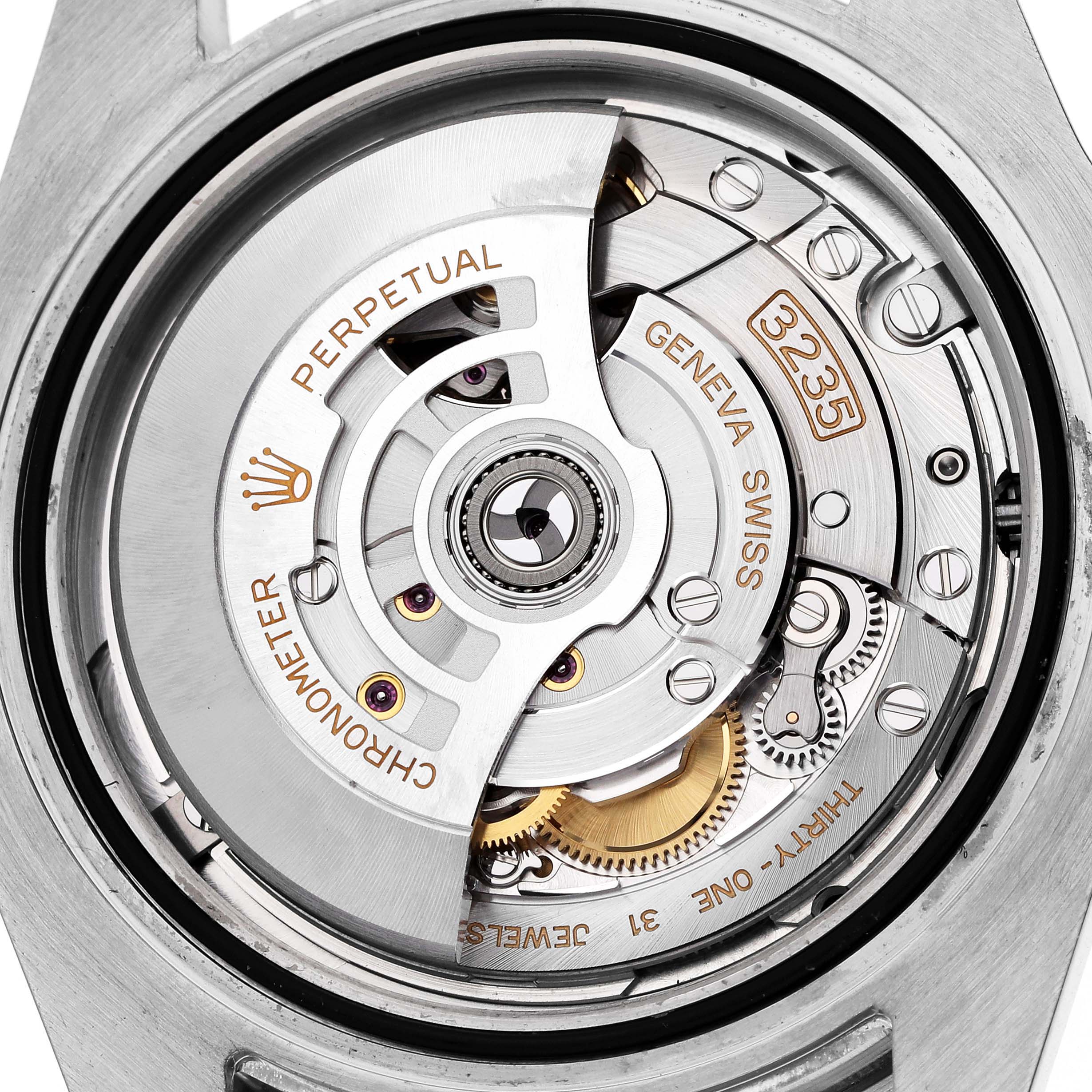 The image shows the movement of a Rolex Submariner 126610 Men's Stainless Steel Black Dial, featuring the rotor and intricate mechanisms from the rear angle.