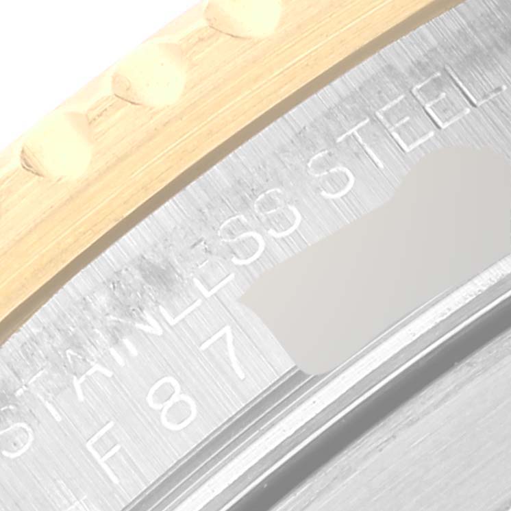 This image shows a close-up of the stainless steel case back and part of the bezel of a Rolex Submariner 16613 Men's Steel and Gold (two tone) Blue Dial 16613 Men's Steel and Gold (two tone) Blue Dial watch.