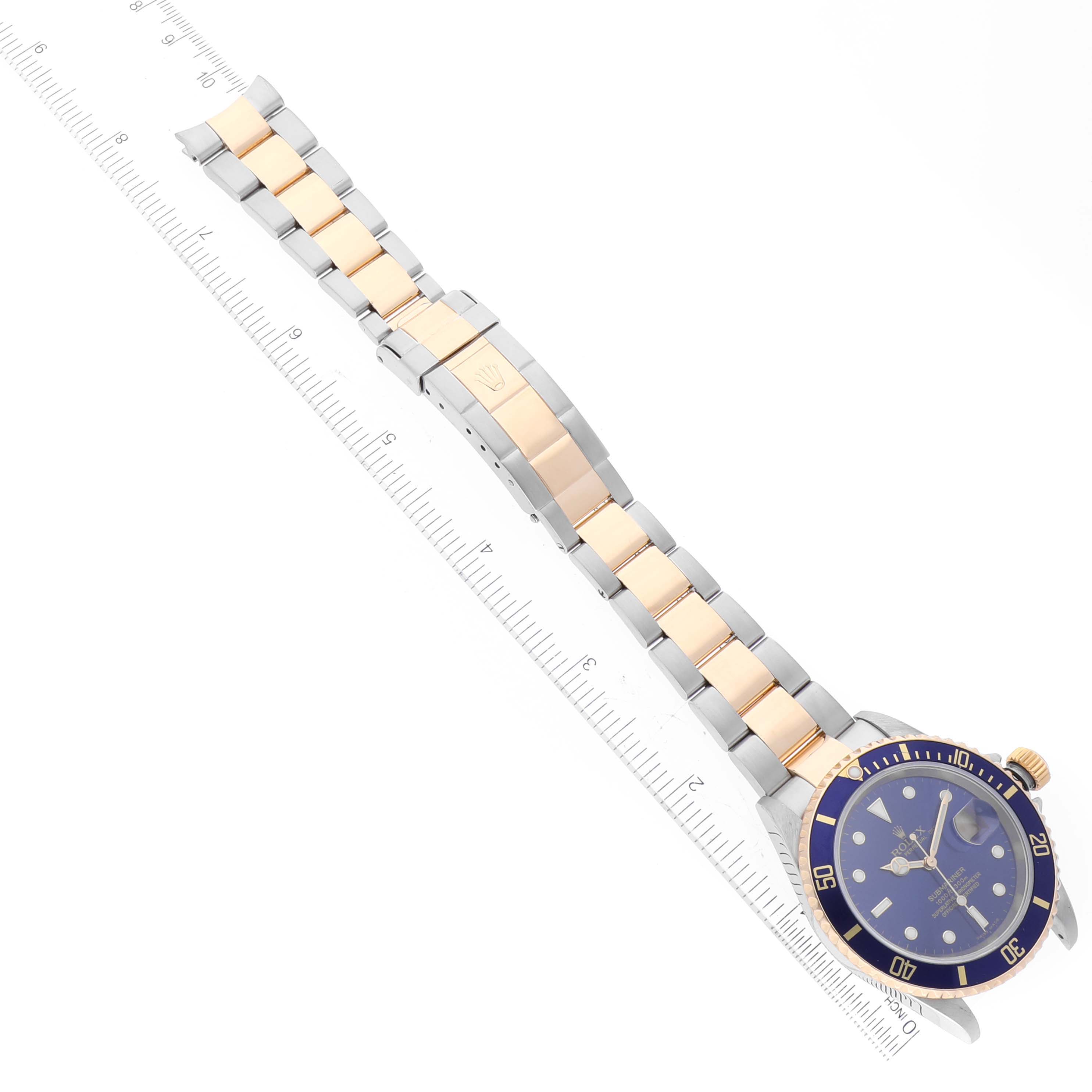 The image shows a Rolex Submariner 16613 Men's Steel and Gold (two tone) Blue Dial 16613 Men's Steel and Gold (two tone) Blue Dial watch angled diagonally, highlighting its blue bezel, dial, and two-tone bracelet.