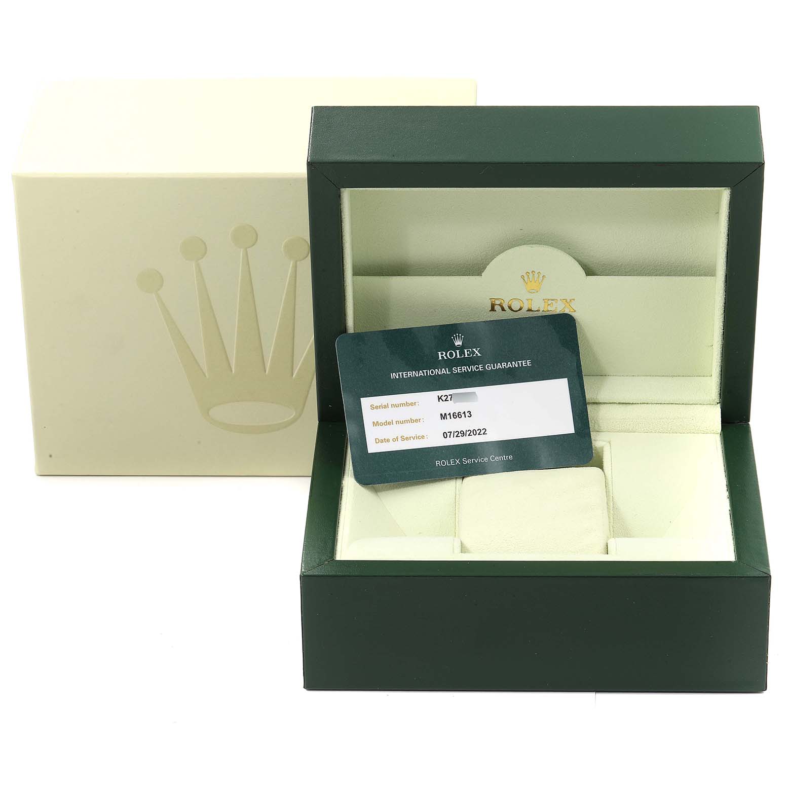 The image shows a green Rolex box for a Submariner model with an international service guarantee card.