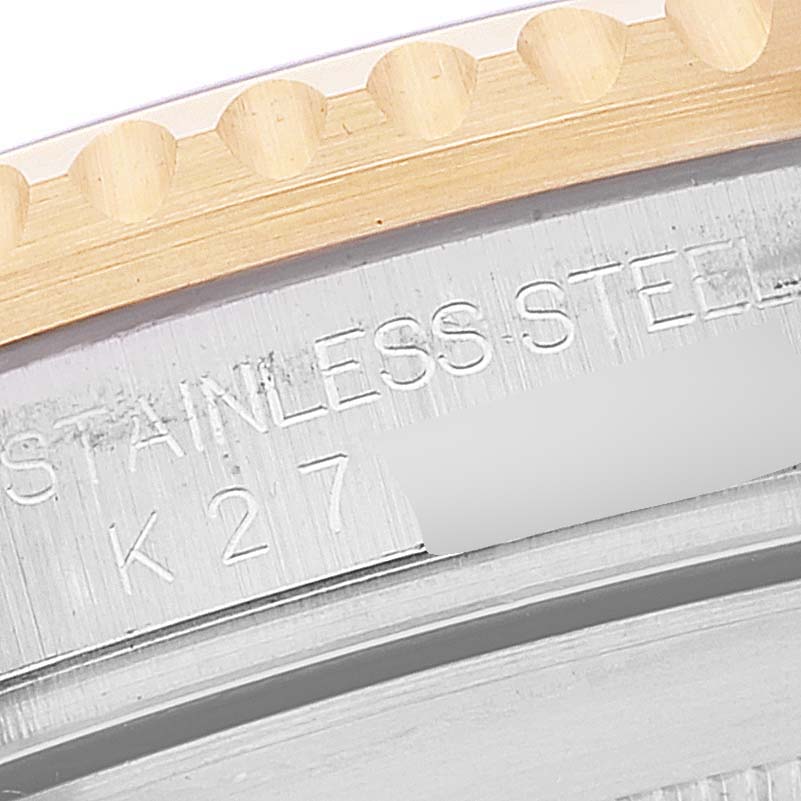 This close-up of the Rolex Submariner 16613 Men
s Steel and Gold (two tone) Blue Dial 16613 Men
s Steel and Gold (two tone) Blue Dial watch shows part of the bezel and the engraved stainless steel text on the case.