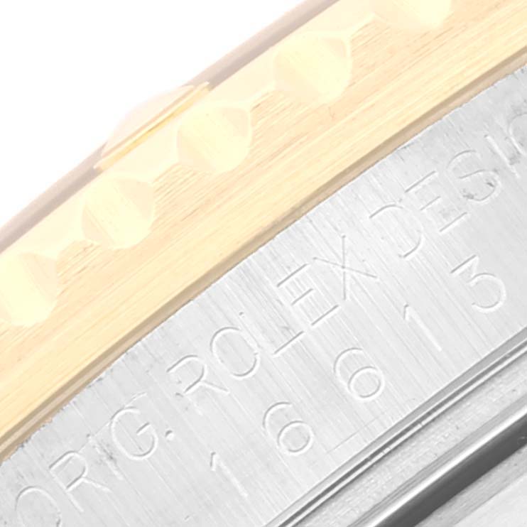 The image shows a close-up of the bezel and case side of a Rolex Submariner 16613 Men's Steel and Gold (two tone) Blue Dial 16613 Men's Steel and Gold (two tone) Blue Dial watch, highlighting engravings and markers.