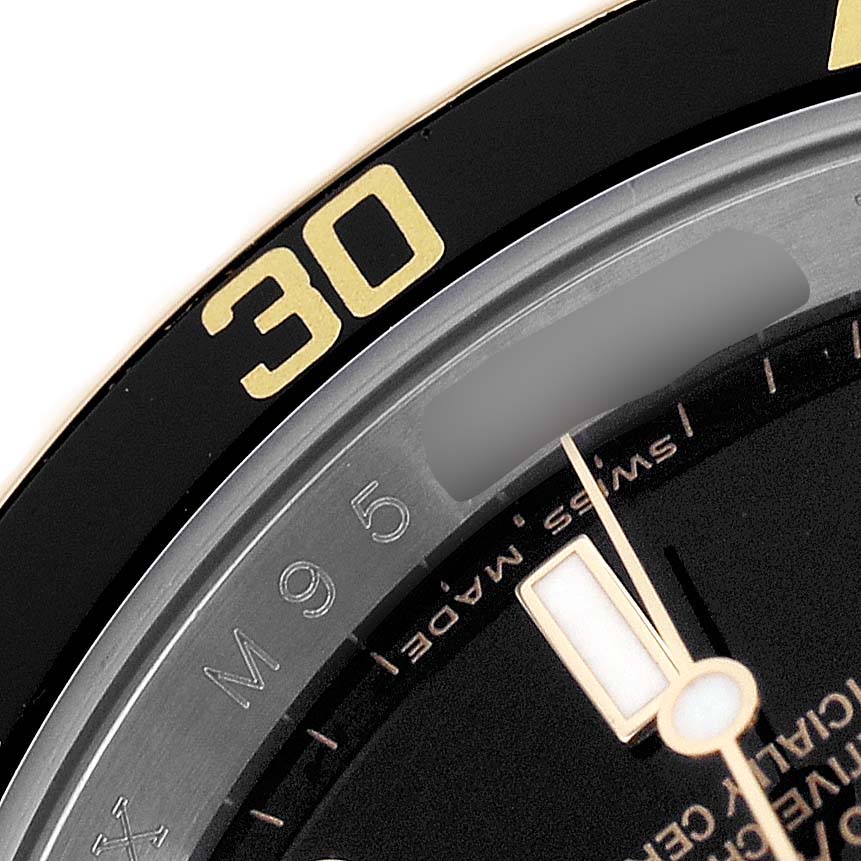 The image shows a close-up of the bezel, part of the dial, and markers of a Rolex Submariner 16613 Men's Steel and Gold (two tone) Black Dial.