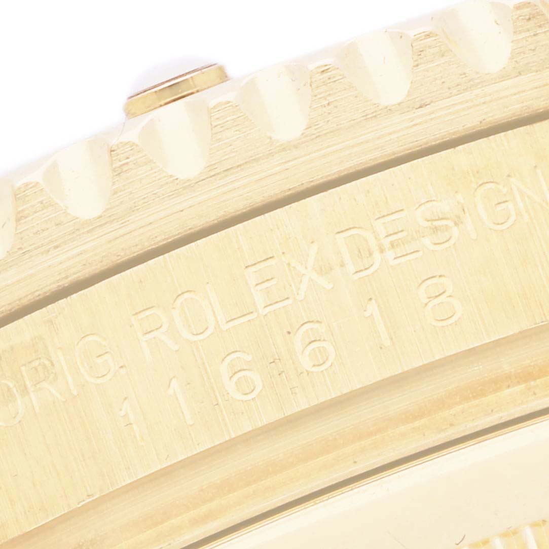 The image shows a close-up of the engraved side of the bezel on a Rolex Submariner 116618 Men's Yellow Gold Black Dial, highlighting the model number.