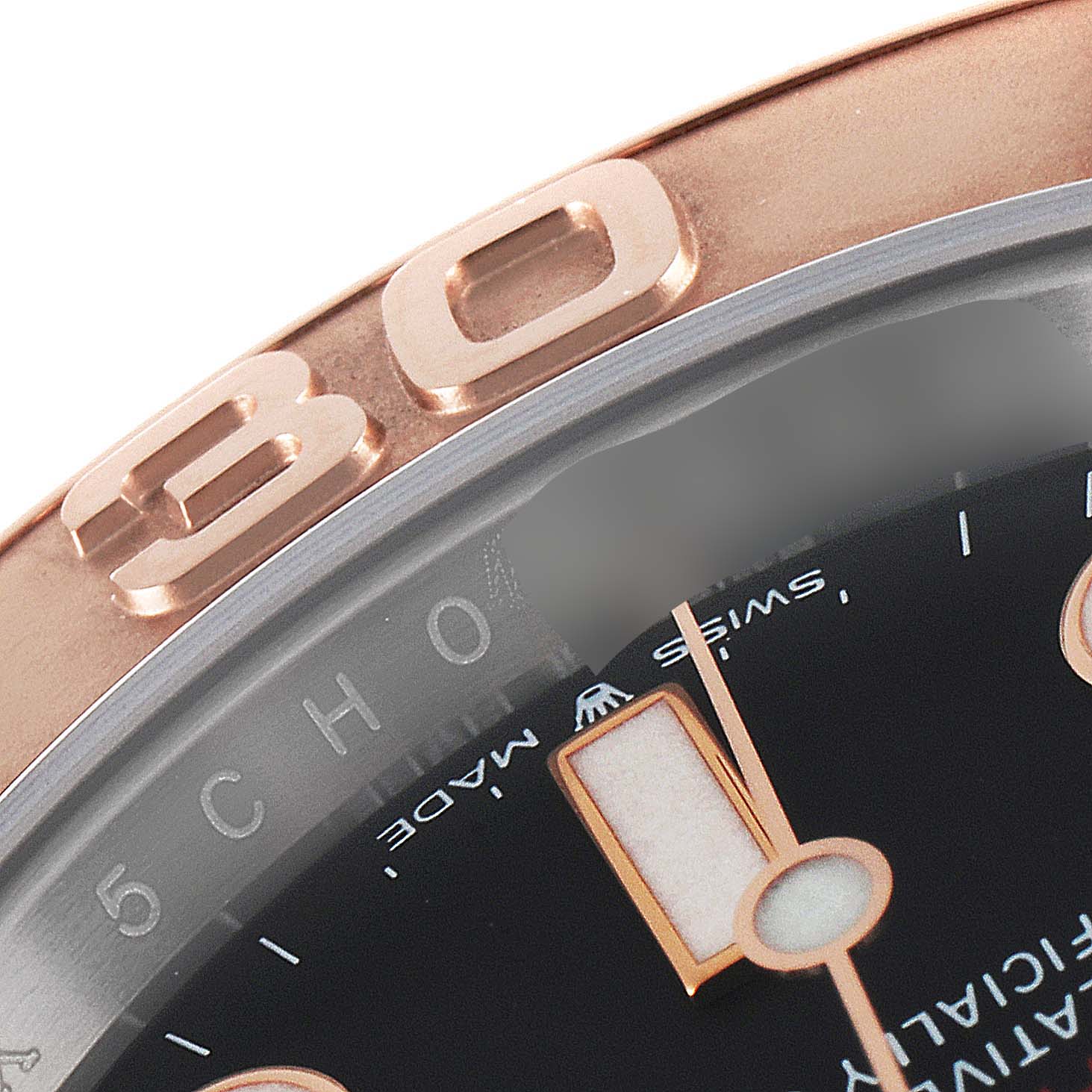 This close-up of the Rolex Yacht-Master 126621 Men
s Steel and Gold (two tone) Black Dial 126621 Men
s Steel and Gold (two tone) Black Dial watch shows the bezel with the "30" marker, part of the dial, and the minute hand.