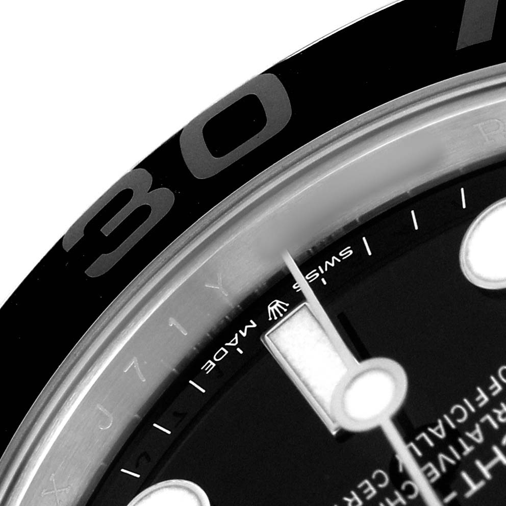 The image shows a close-up of the Rolex Yacht-Master 226659 Men's White Gold Black Dial's bezel and a portion of the dial.