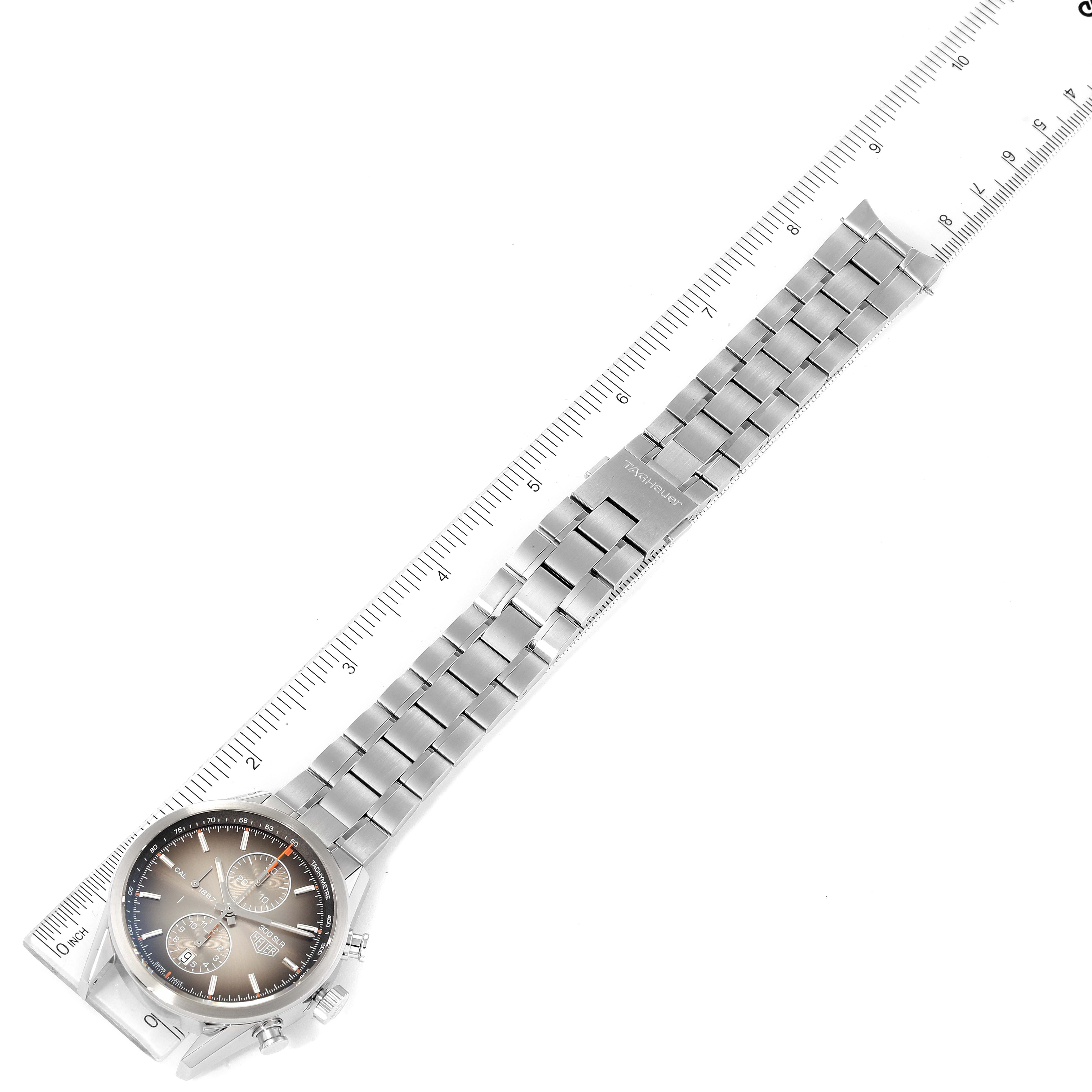 The image shows the Tag Heuer Carrera CAR2112.FC6267 Men's Stainless Steel Brown Dial CAR2112.FC6267 Men's Stainless Steel Brown Dial watch laying flat with its bracelet fully extended and placed over a ruler for scale.