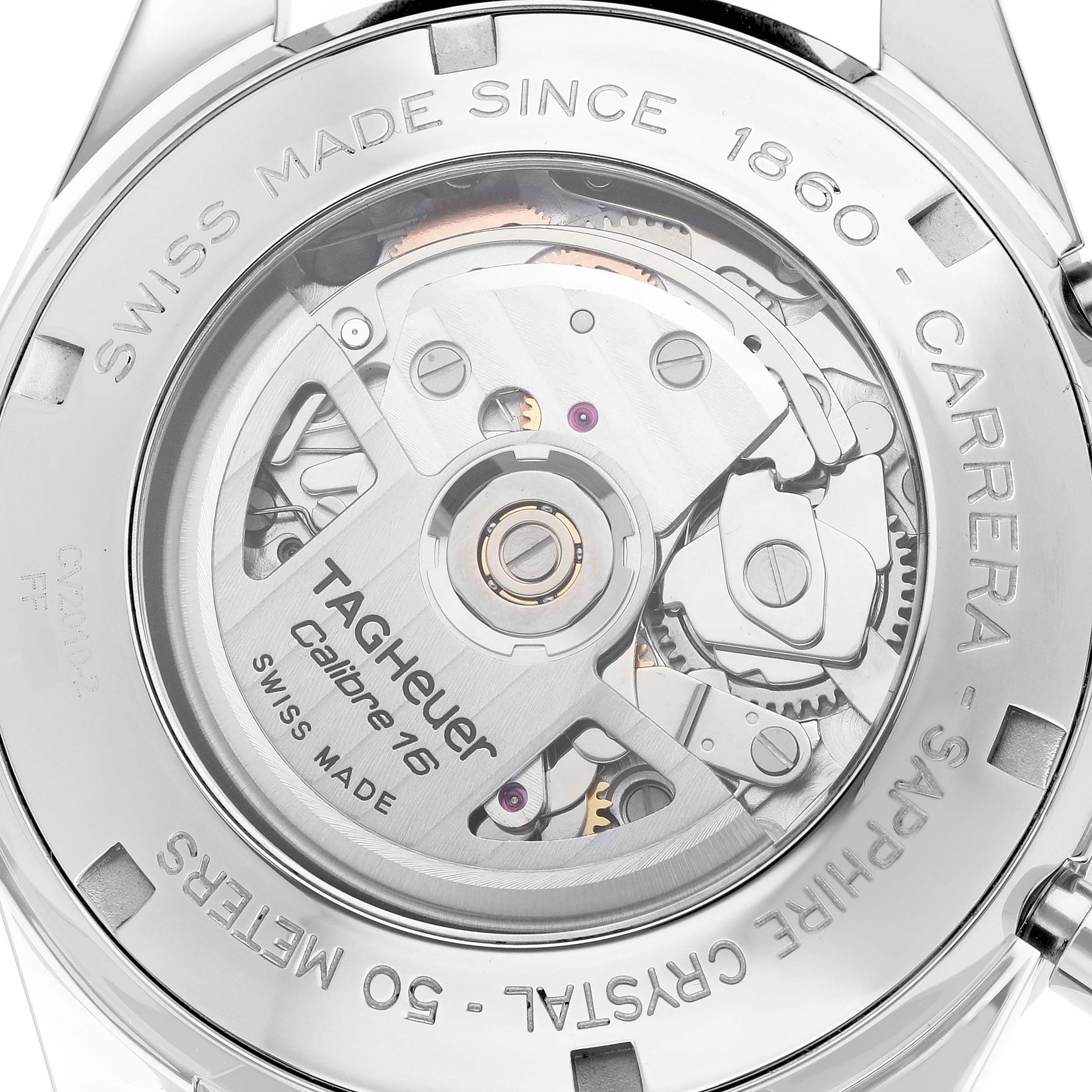 The image shows the back view of the Tag Heuer Carrera CV2010 Men's Stainless Steel Black Dial, revealing its Calibre 16 movement and detailed engravings.