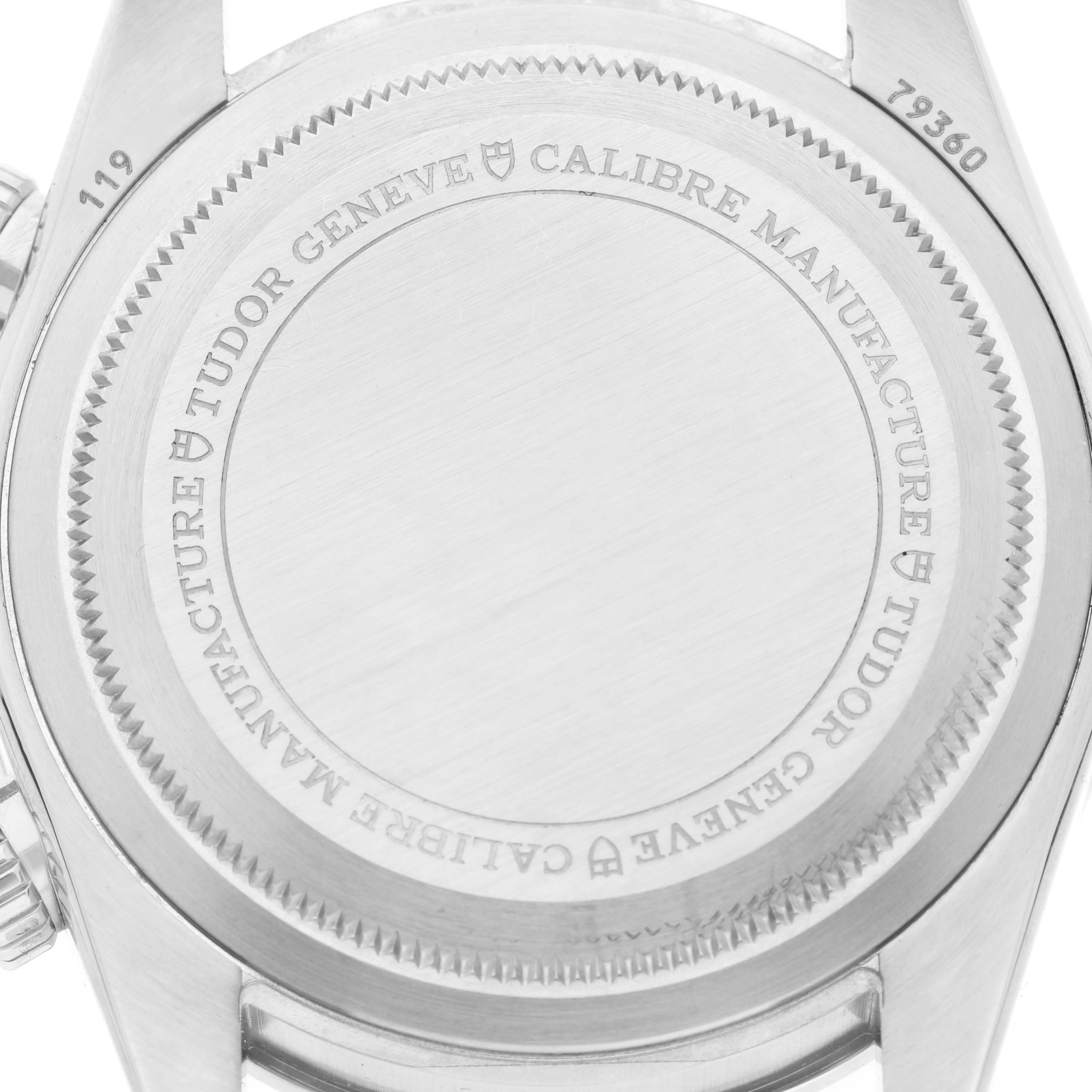 The image shows the case back of a Tudor Heritage Black Bay M79360B-0002 Men's Stainless Steel Blue Dial watch, featuring engraved brand details and text.