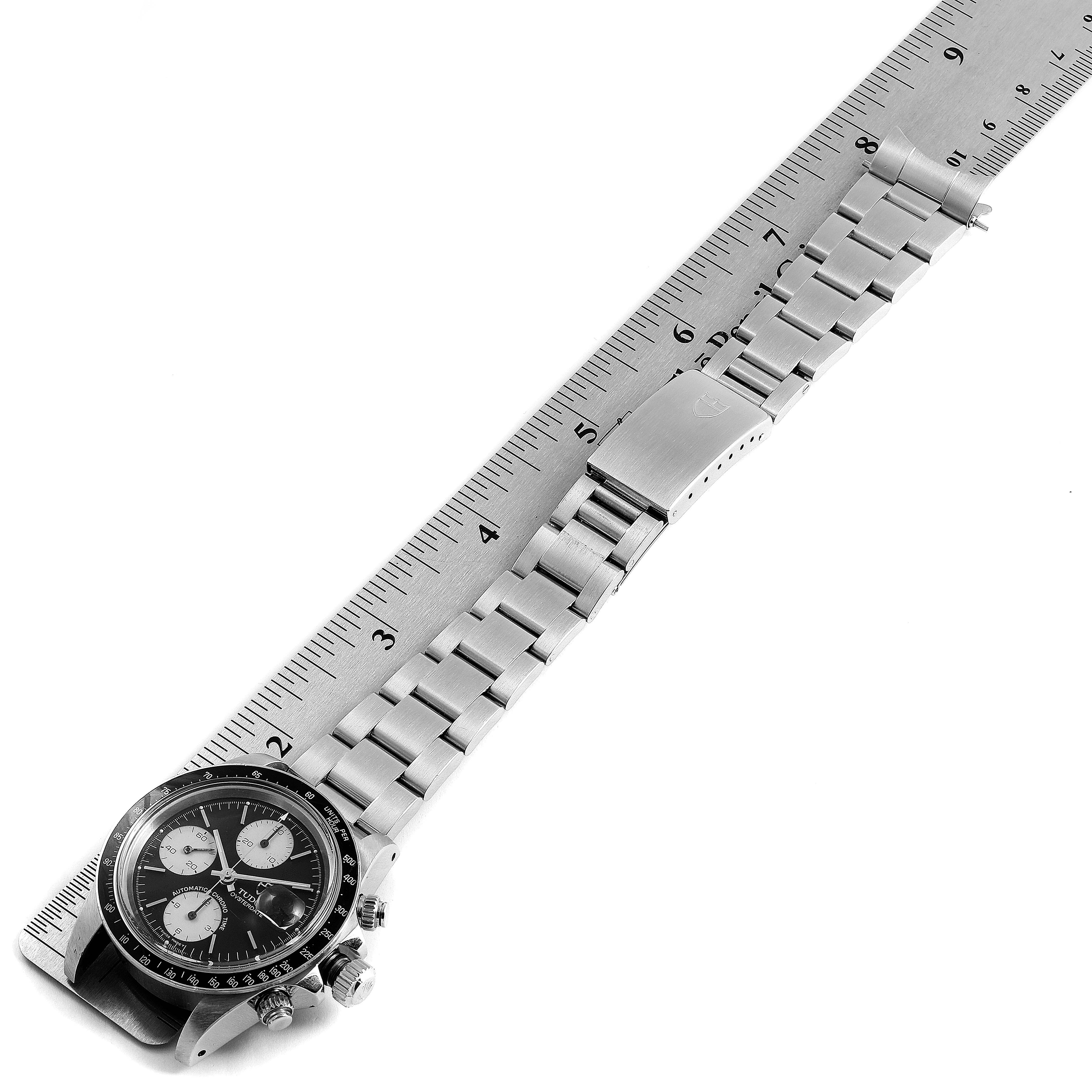 The image shows a Tudor Big Block 79170 Men
s Stainless Steel Black Dial 79170 Men
s Stainless Steel Black Dial watch laid flat, showcasing the face, bracelet, and clasp, with a ruler for scale.