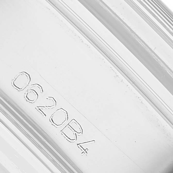 The image shows a close-up of the engraved serial number on a Breitling Premier AB0118 Men's Stainless Steel Silver Dial watch component.