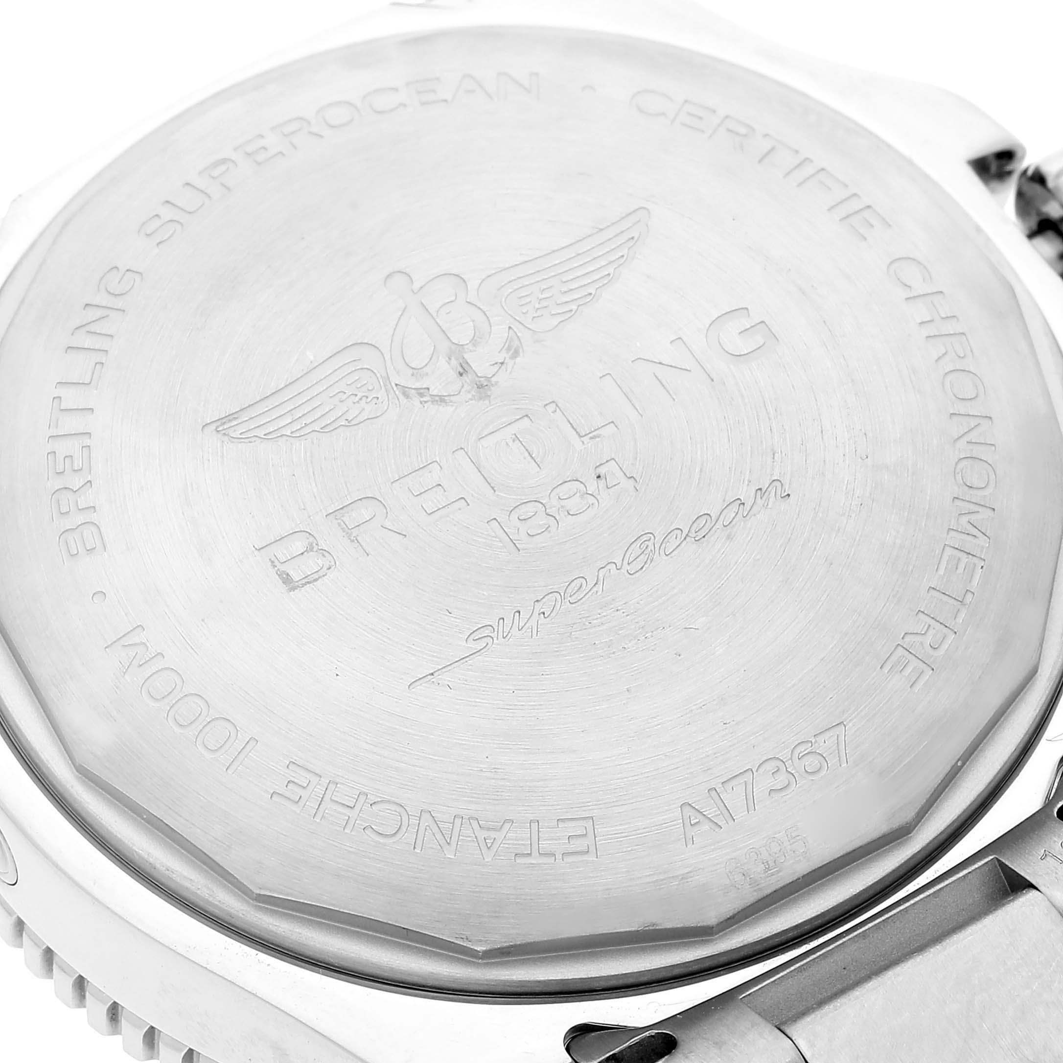 The image shows the back casing of a Breitling Superocean A17367 Men
s Stainless Steel Blue Dial A17367 Men
s Stainless Steel Blue Dial watch, focusing on the engravings and detailing.