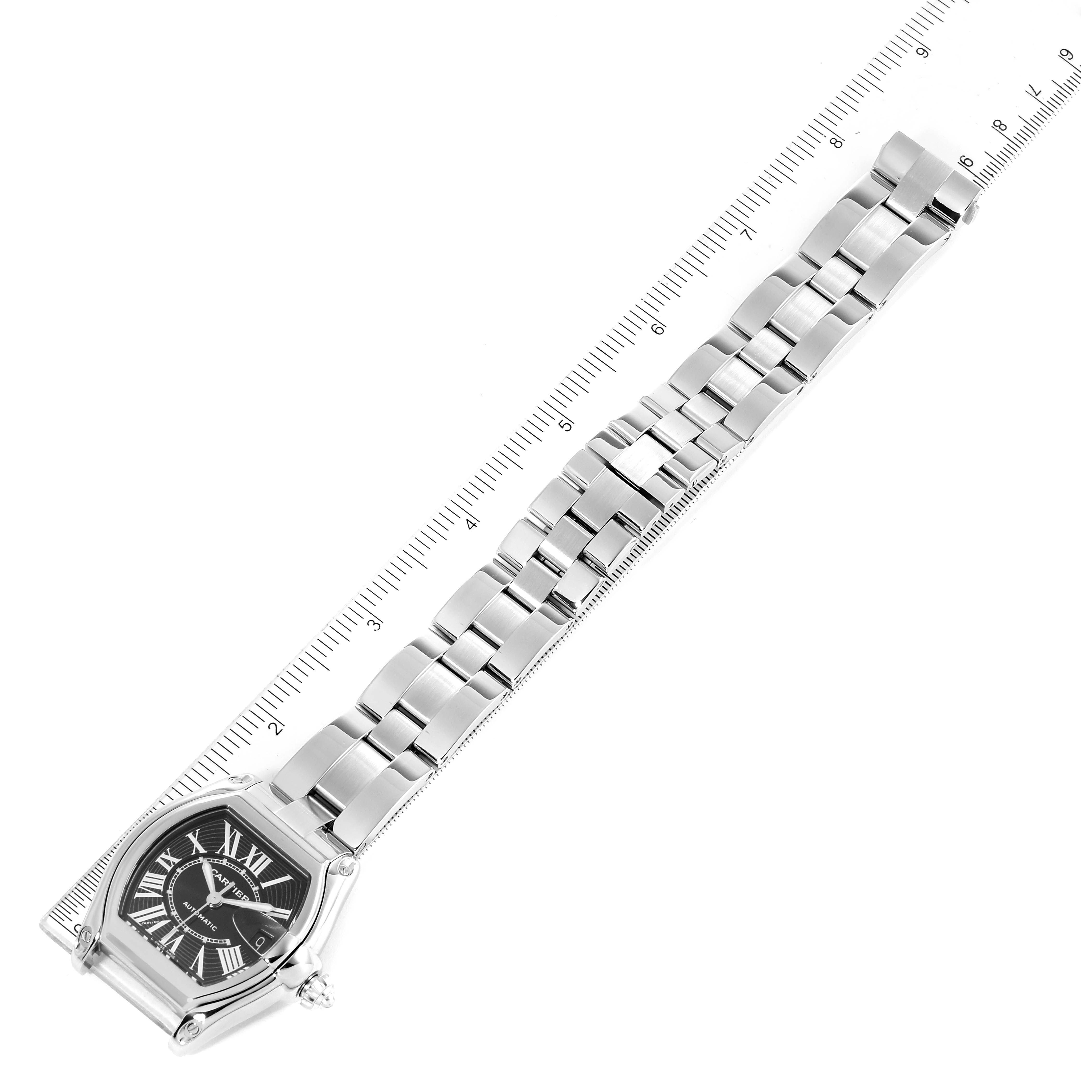 This image shows a Cartier Roadster W62041V3 Men's Stainless Steel Black Dial W62041V3 Men's Stainless Steel Black Dial watch from a top-down angle, highlighting its face, band, and a ruler for scale.