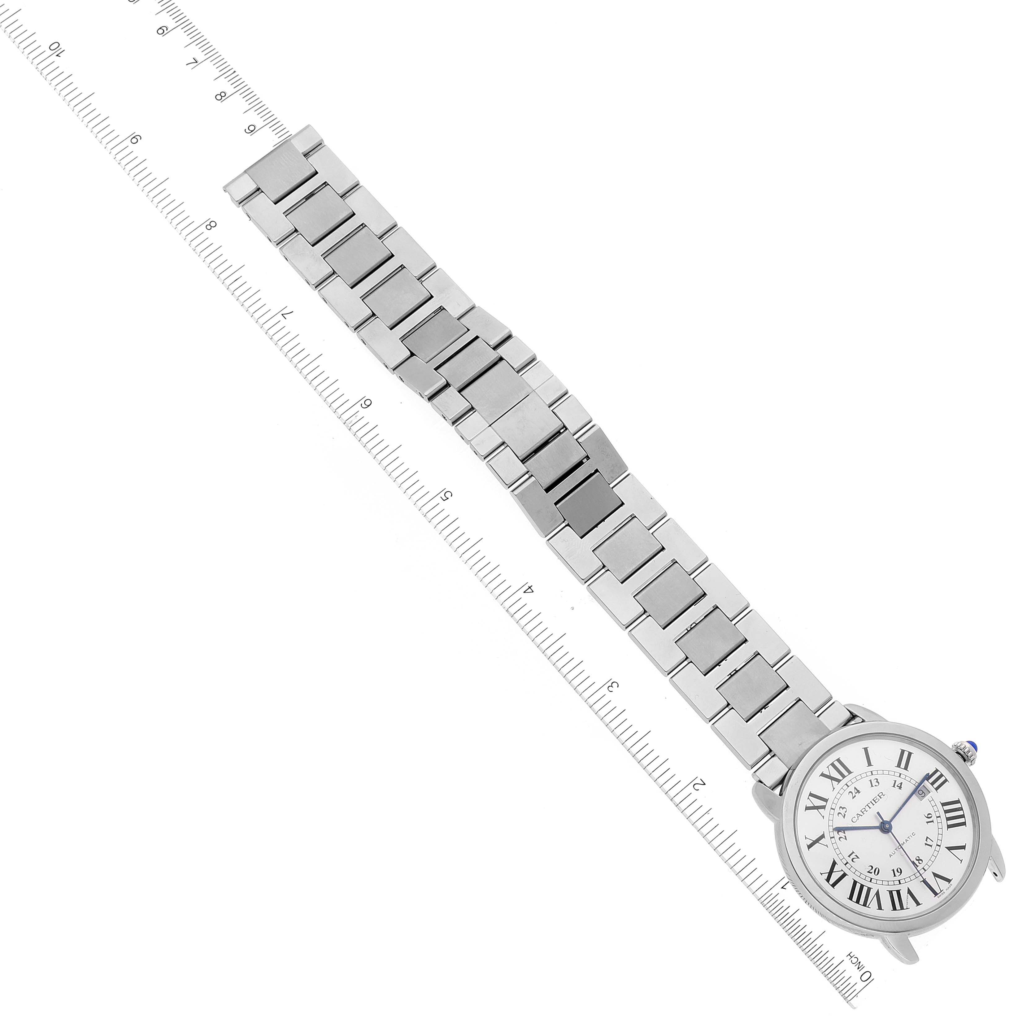 The Cartier Ronde W6701011 Men's Stainless Steel Silver Dial W6701011 Men's Stainless Steel Silver Dial watch is shown diagonally, displaying its face, bracelet, and part of a ruler for scale.