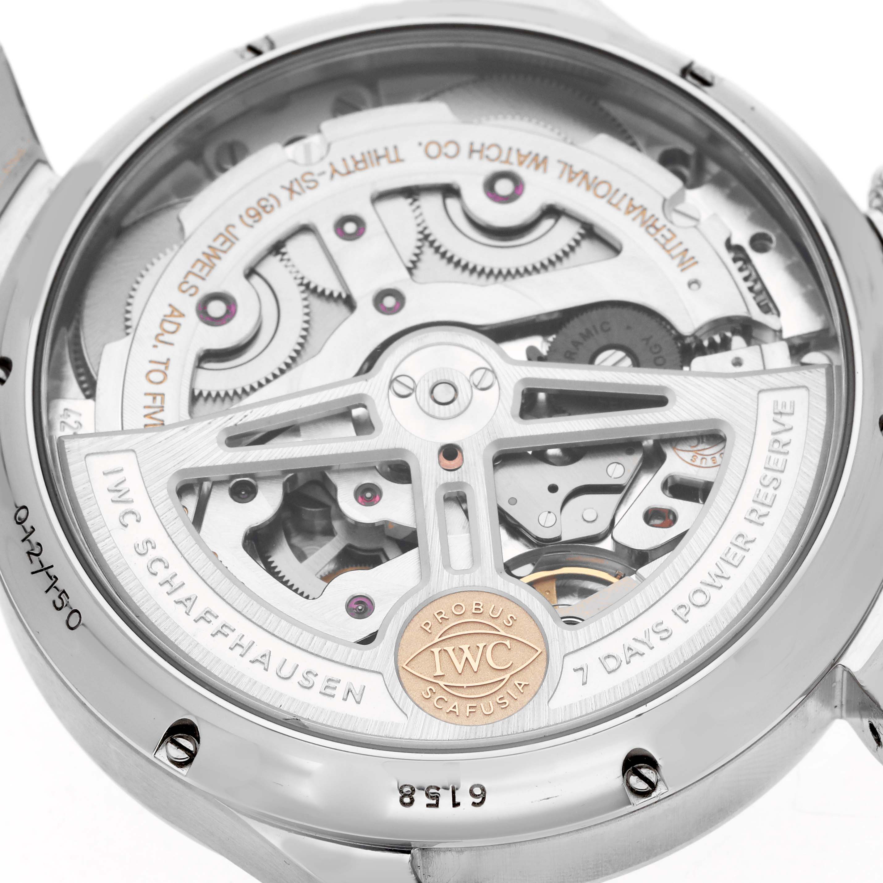 The IWC Portuguese IW503510 Men's Stainless Steel Green Dial model is shown from the back, displaying its intricate movement and 7-day power reserve mechanism.