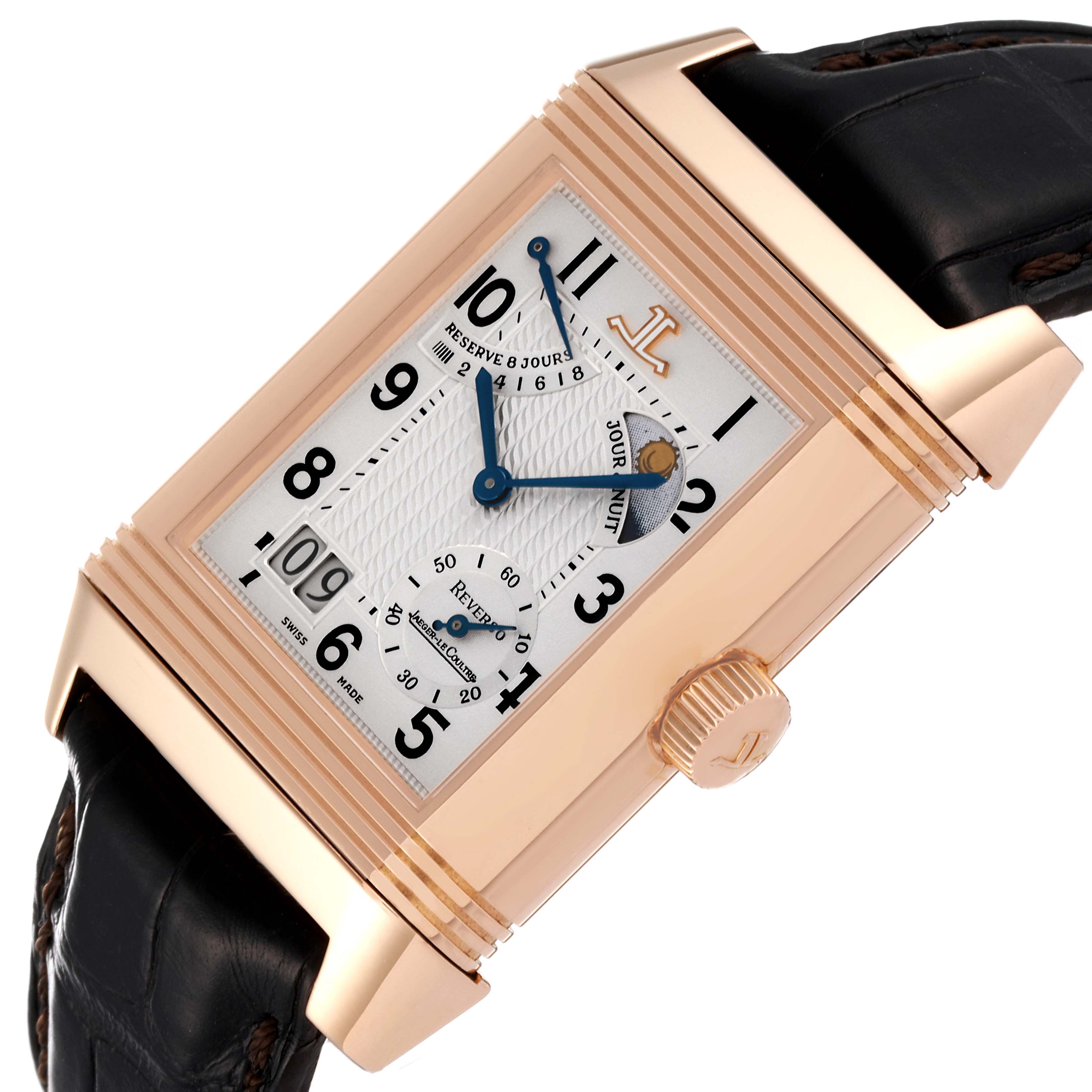 The image shows a Jaeger LeCoultre Reverso Q3002420 Men's Rose Gold Silver Dial Q3002420 Men's Rose Gold Silver Dial watch at an angle displaying the dial, crown, and part of the leather strap.