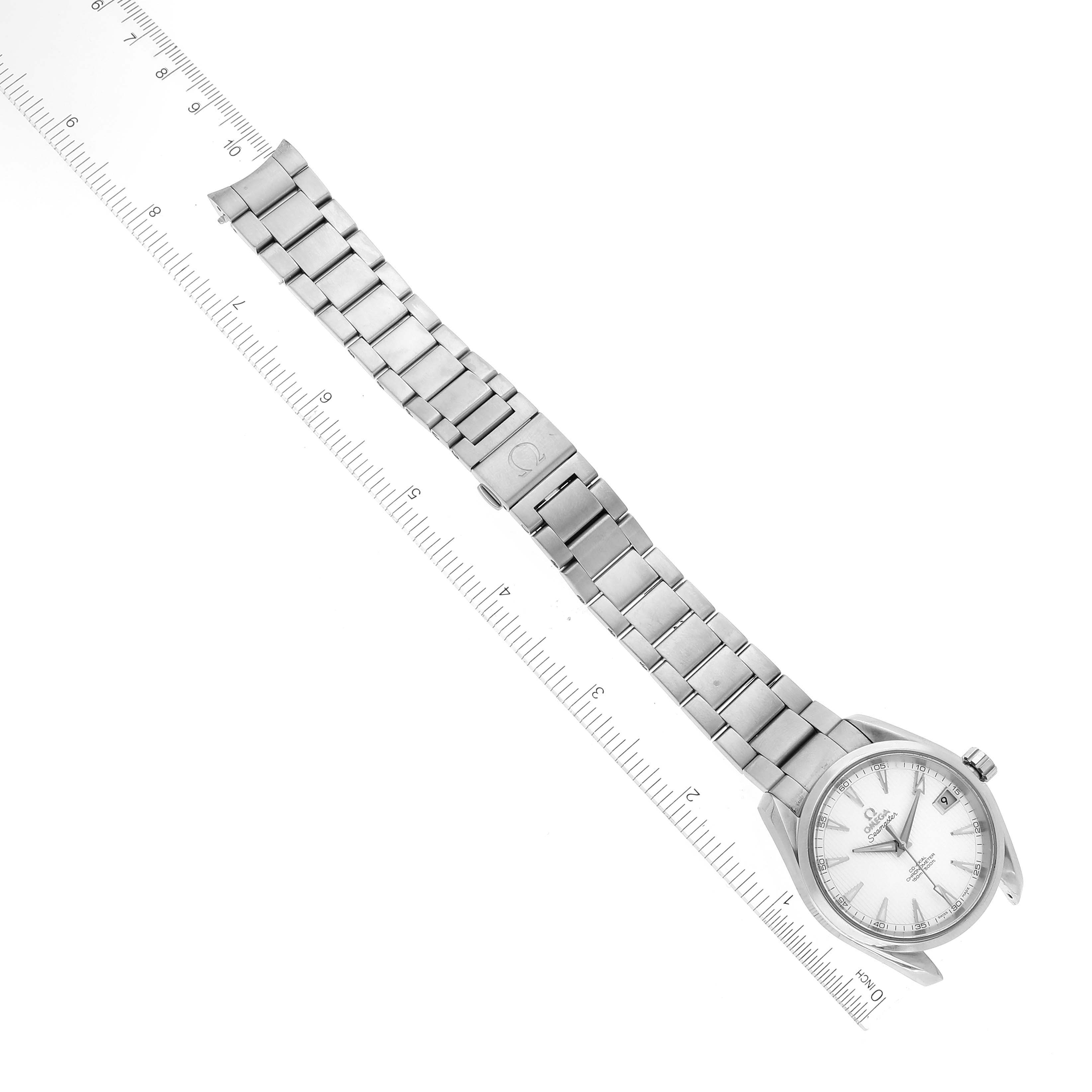 The image shows an angled top-down view of an Omega Aqua Terra 231.10.39.21.02.001 Men's Stainless Steel Silver Dial 231.10.39.21.02.001 Men's Stainless Steel Silver Dial watch, displaying its full metal bracelet and face next to a ruler.