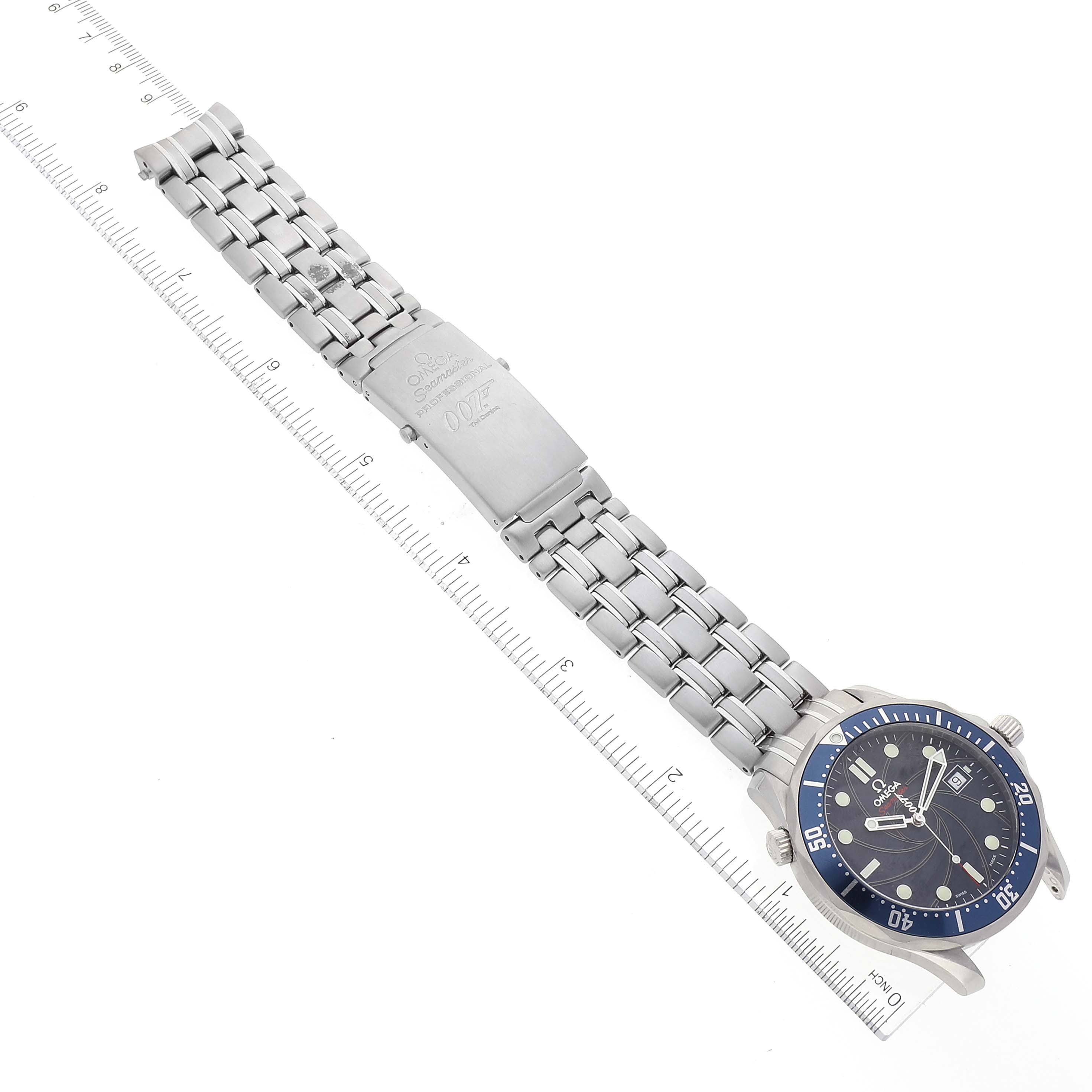 The image shows an Omega Seamaster 2226.80.00 Men's Stainless Steel Blue Dial 2226.80.00 Men's Stainless Steel Blue Dial watch lying flat, displaying its face, bezel, bracelet, and clasp alongside a ruler.