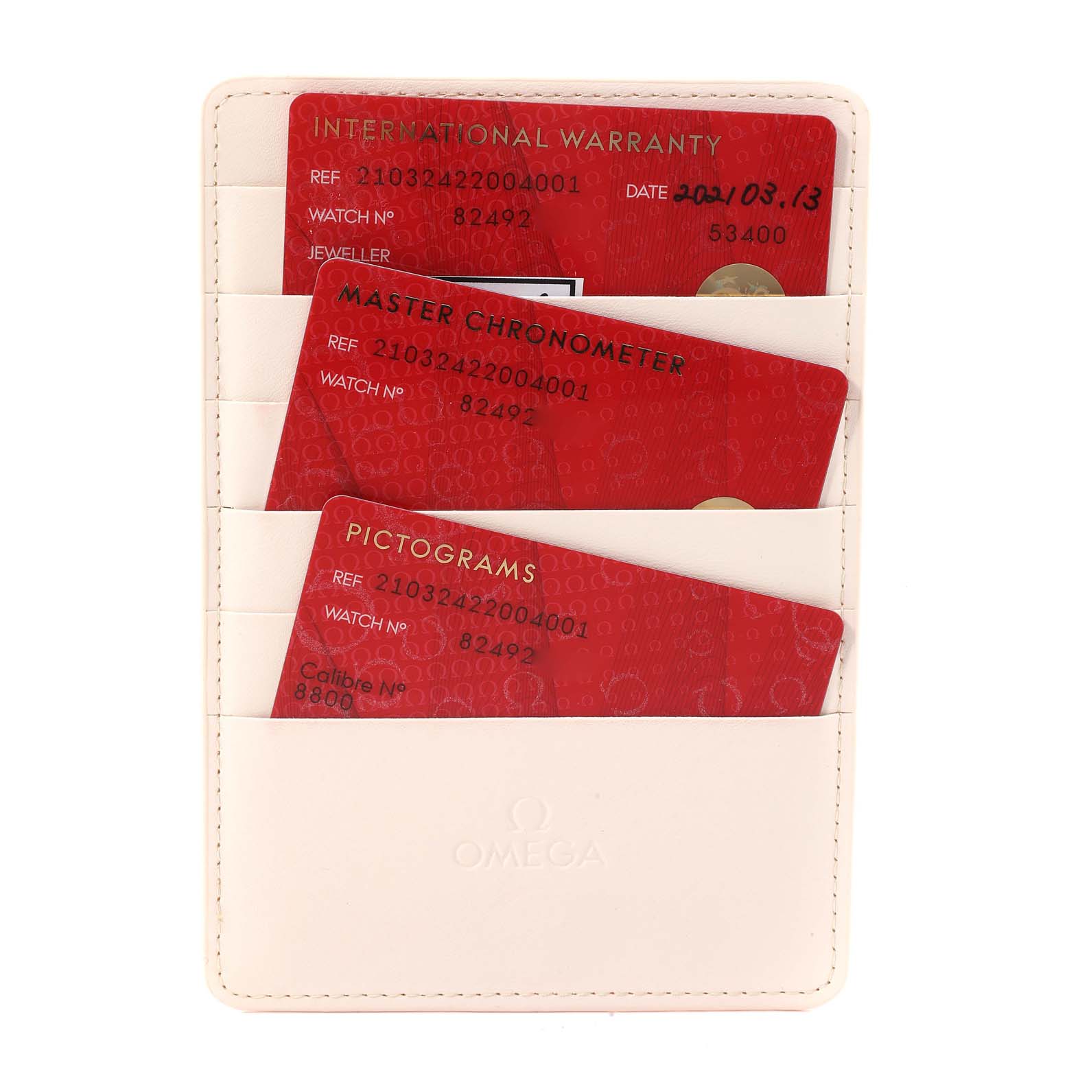 The image shows red warranty and certification cards in a white Omega cardholder for an Omega Seamaster 210.32.42.20.04.001 Men's Stainless Steel White Dial 210.32.42.20.04.001 Men's Stainless Steel White Dial watch.