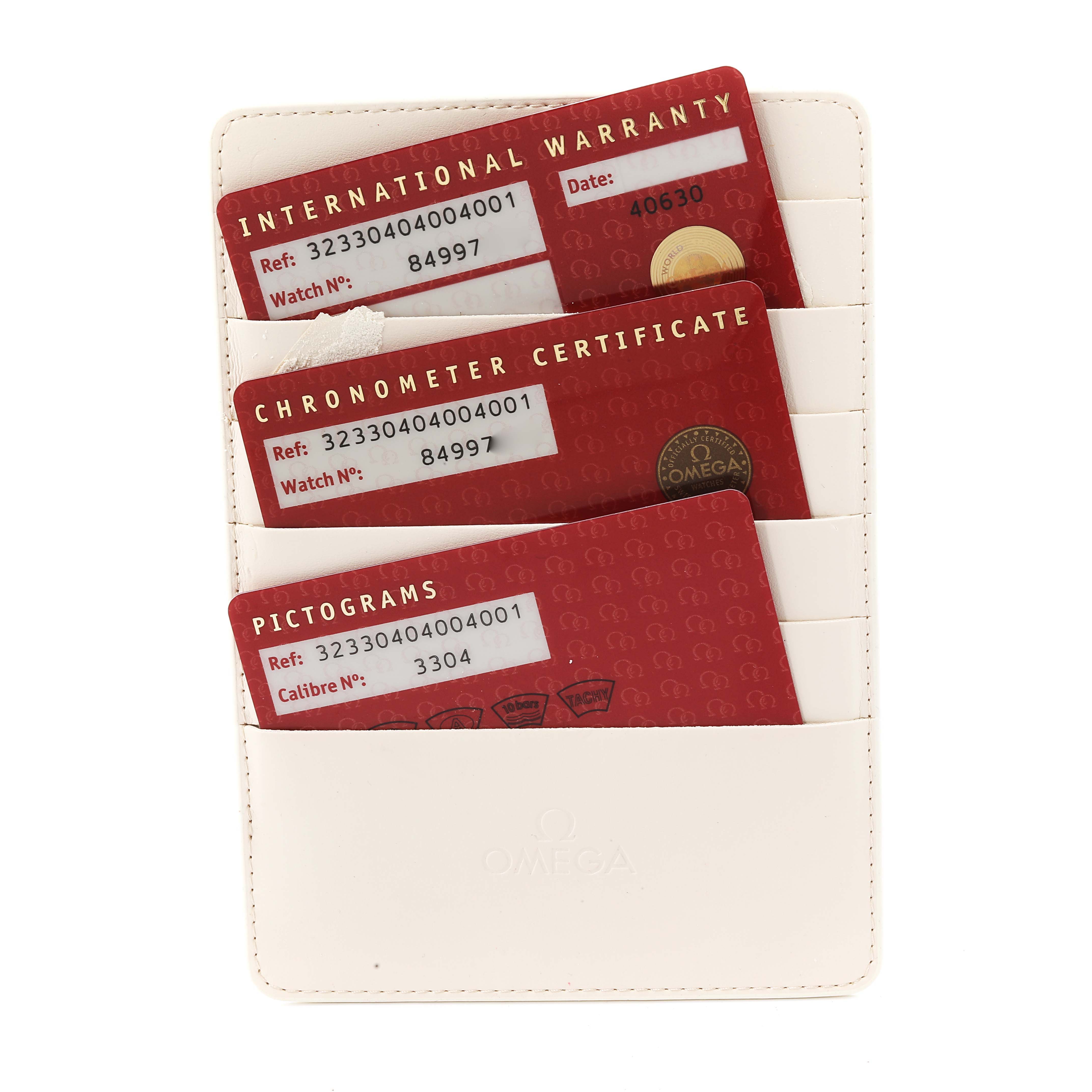 The image shows warranty cards for an Omega Speedmaster 323.30.40.40.04.001 Men's Stainless Steel White Dial 323.30.40.40.04.001 Men's Stainless Steel White Dial, including the International Warranty, Chronometer Certificate, and Pictograms.