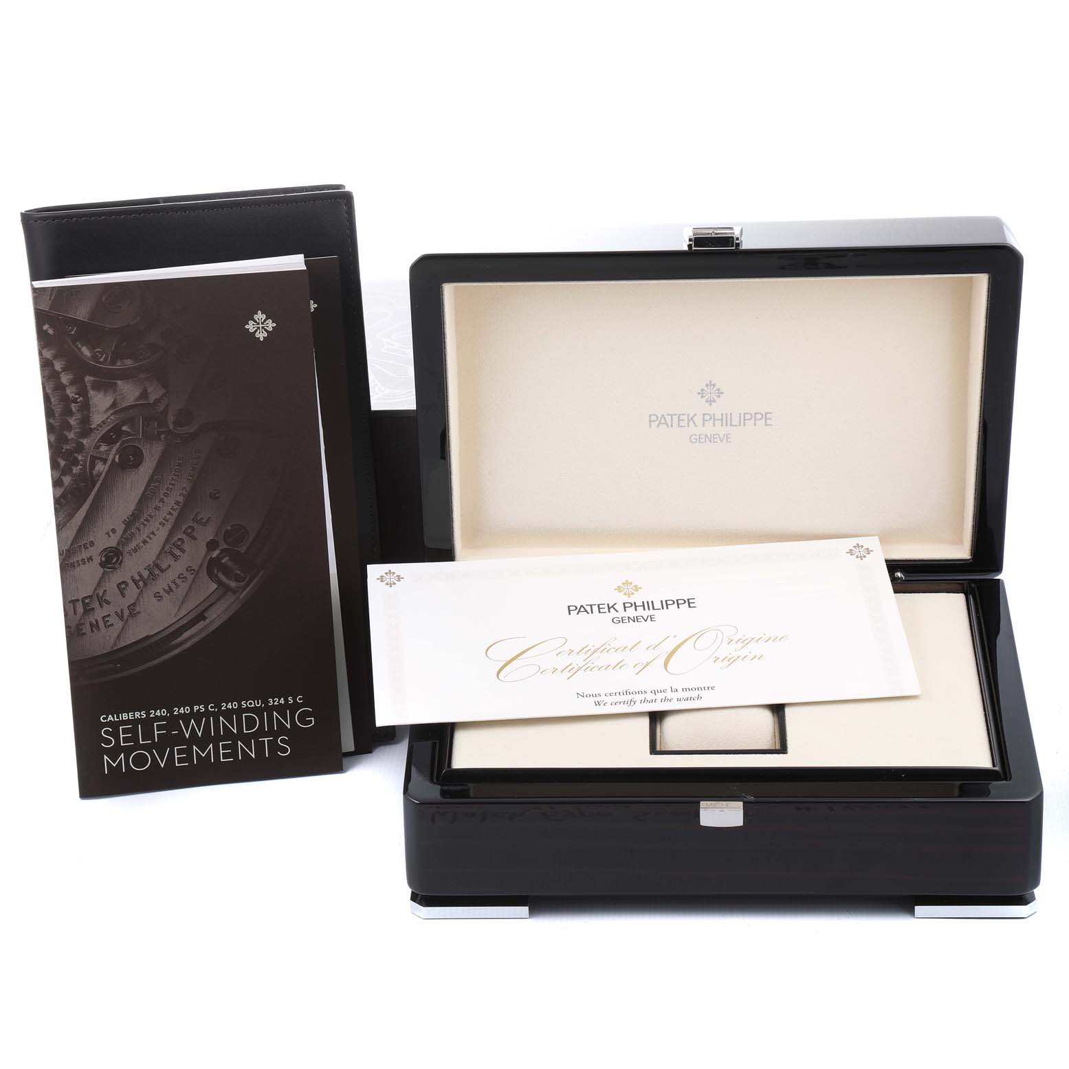 The image shows the packaging and documentation accessories for a Patek Philippe Calatrava 5153G Men
s White Gold Silver Dial 5153G Men
s White Gold Silver Dial watch from a front angle.