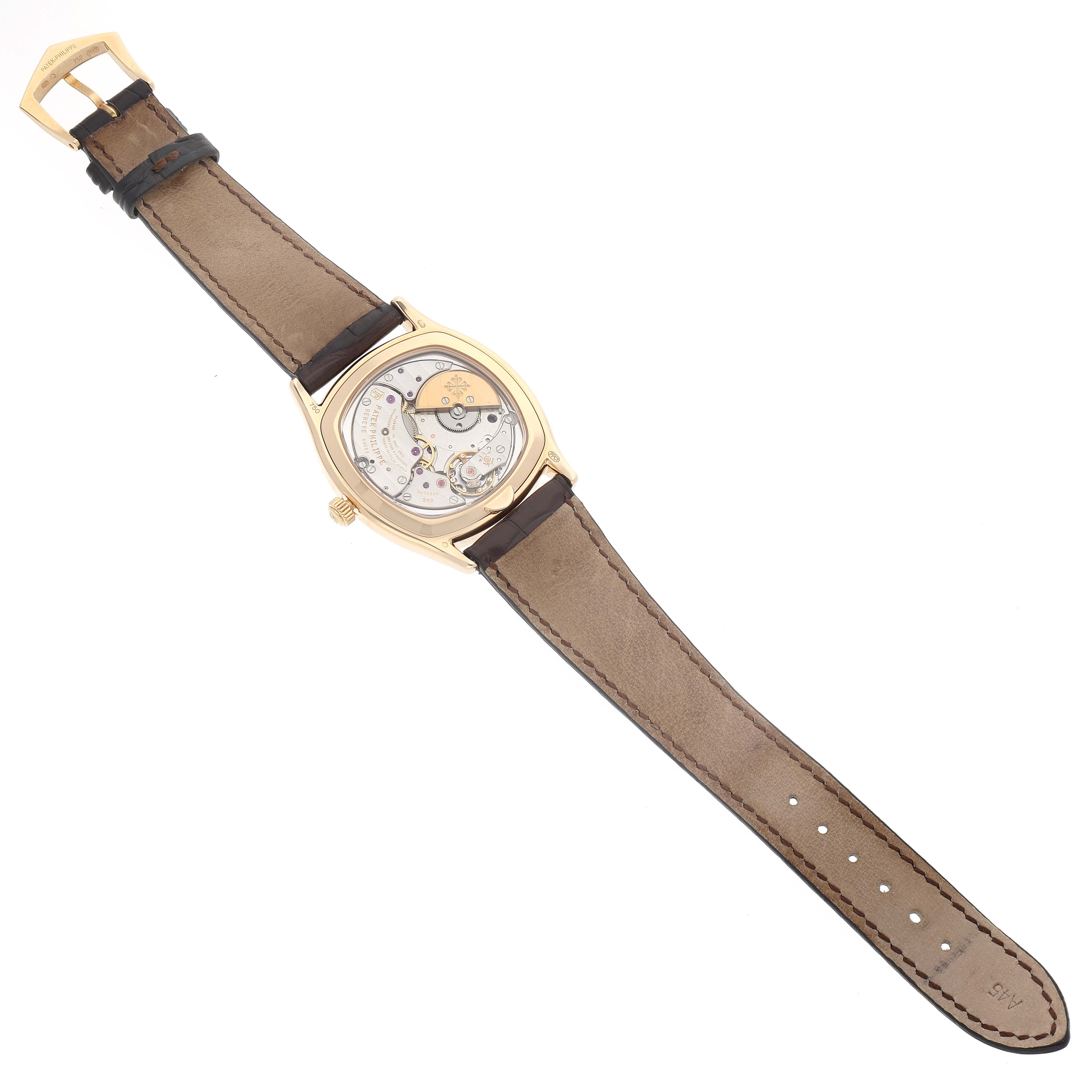 The image shows the back of a Patek Philippe Complications 5940J - 001 Men's Yellow Gold Silver Dial 5940J - 001 Men's Yellow Gold Silver Dial model watch, highlighting its movement and leather strap.