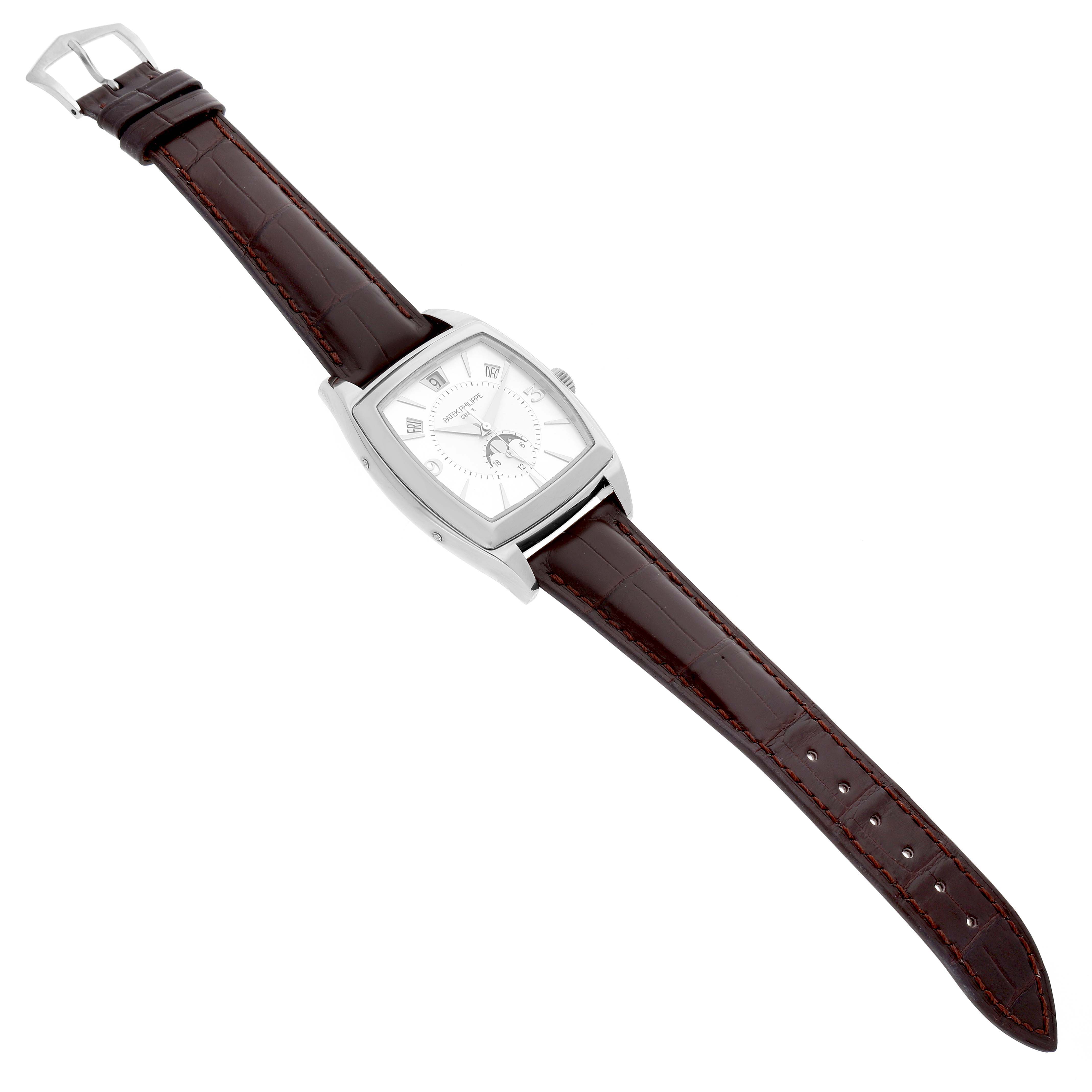 The Patek Philippe Gondolo 5135G-001 Men's White Gold Silver Dial watch is viewed from a top angle, showing the case, silver dial, and brown leather strap with a buckle.