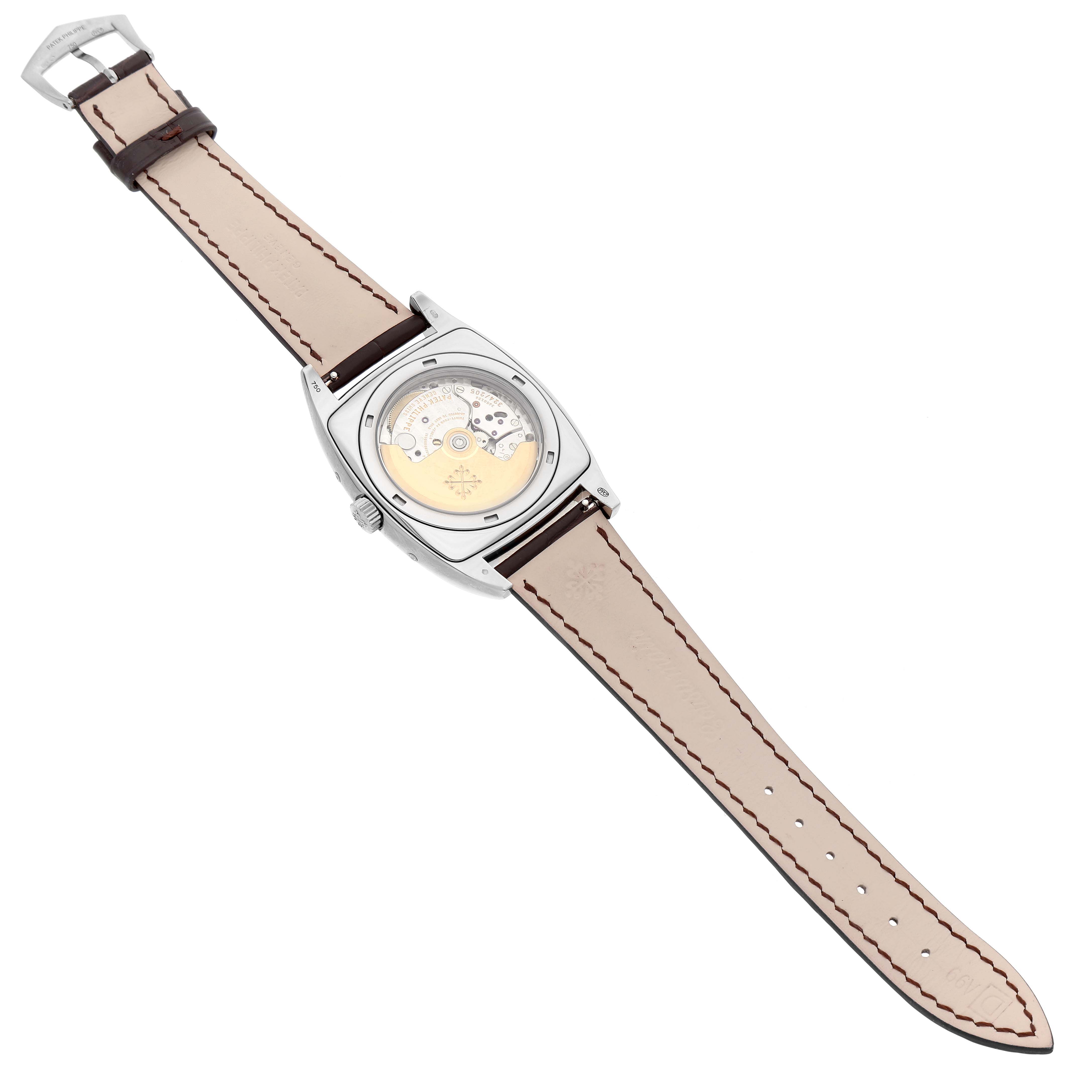 The image shows the back of a Patek Philippe Gondolo 5135G-001 Men's White Gold Silver Dial watch, highlighting its open case back and detailed movement.