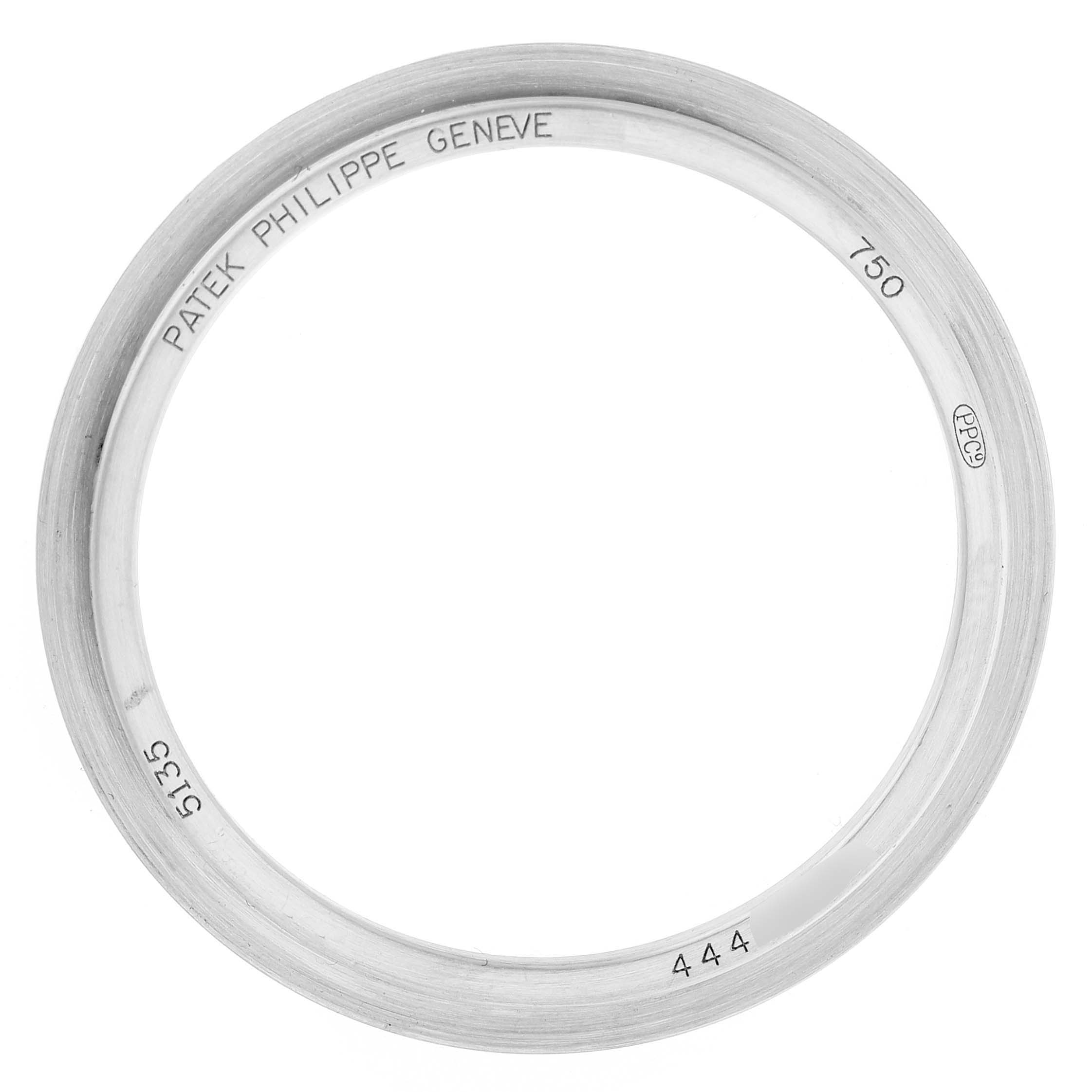 The image shows a top view of the bezel for the Patek Philippe Gondolo 5135G-001 Men's White Gold Silver Dial watch, engraved with the brand and model details.