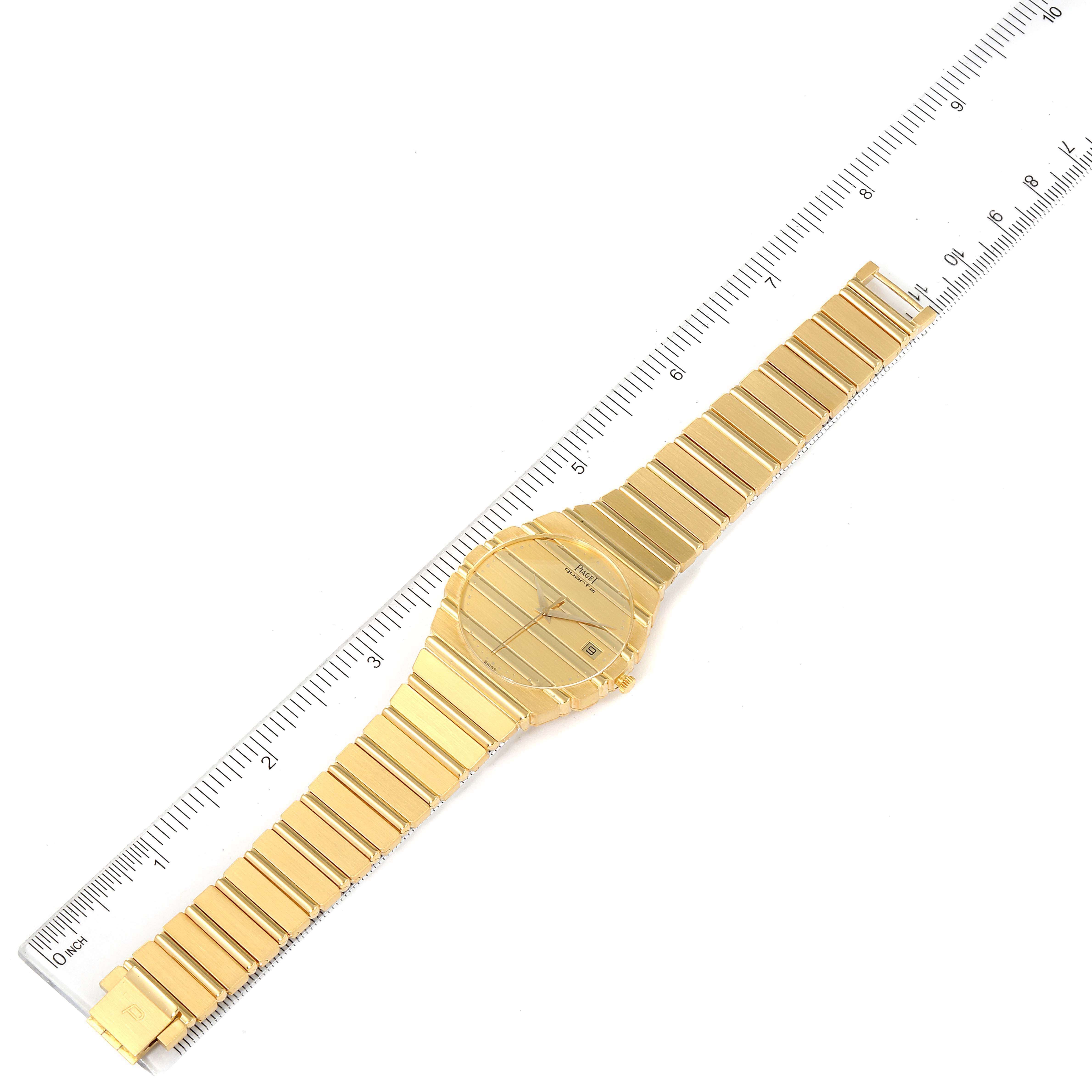 The Piaget 15661C701 Men's Yellow Gold Champagne Dial 15661C701 Men's Yellow Gold Champagne Dial Polo 18K Yellow Gold Champagne Dial Mens Watch 15561 is shown laid flat, with a ruler alongside for scale.