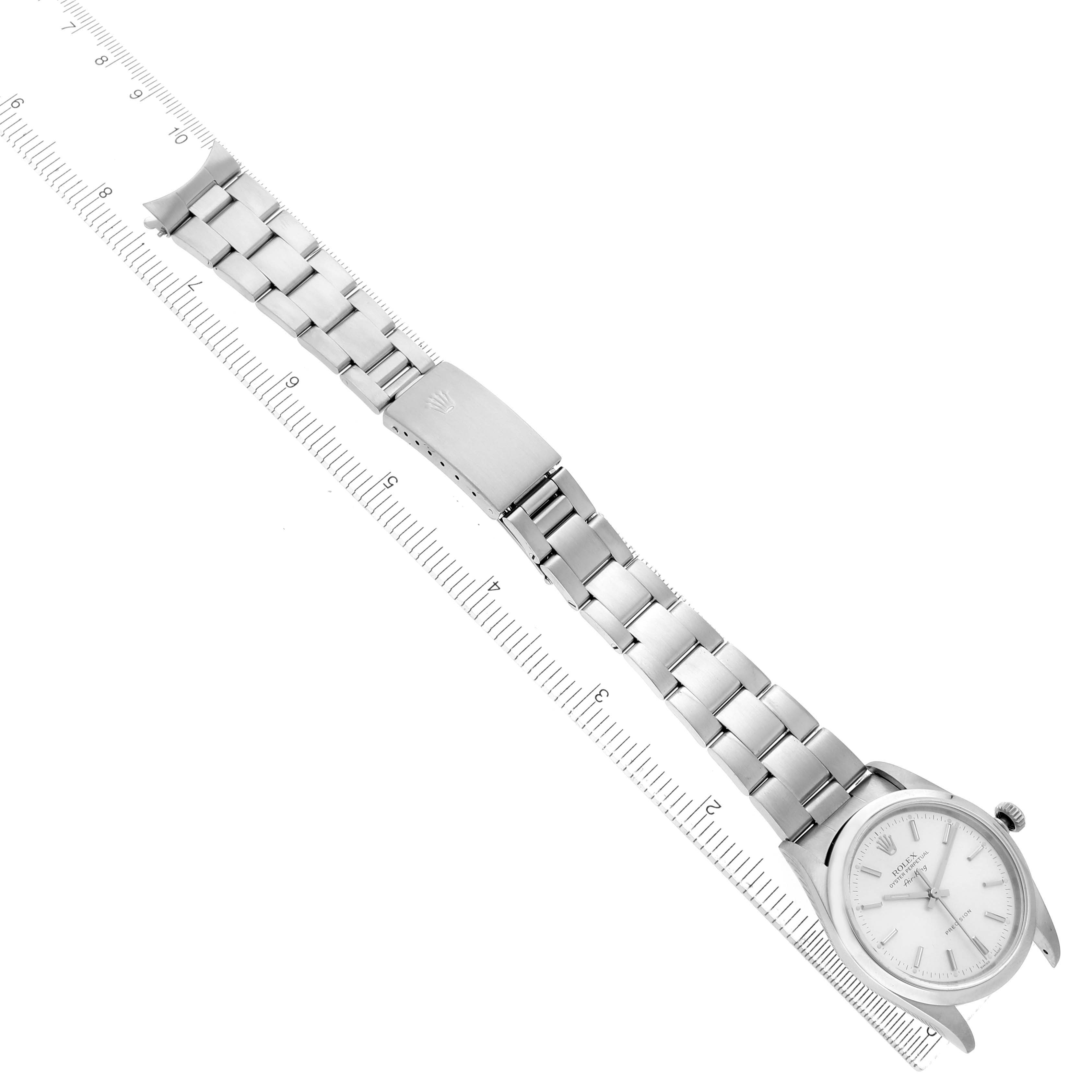 The Rolex Air-King 14000 Men's Stainless Steel Silver Dial watch is shown from a top-down angle, featuring the full bracelet and clasp alongside a ruler for scale.