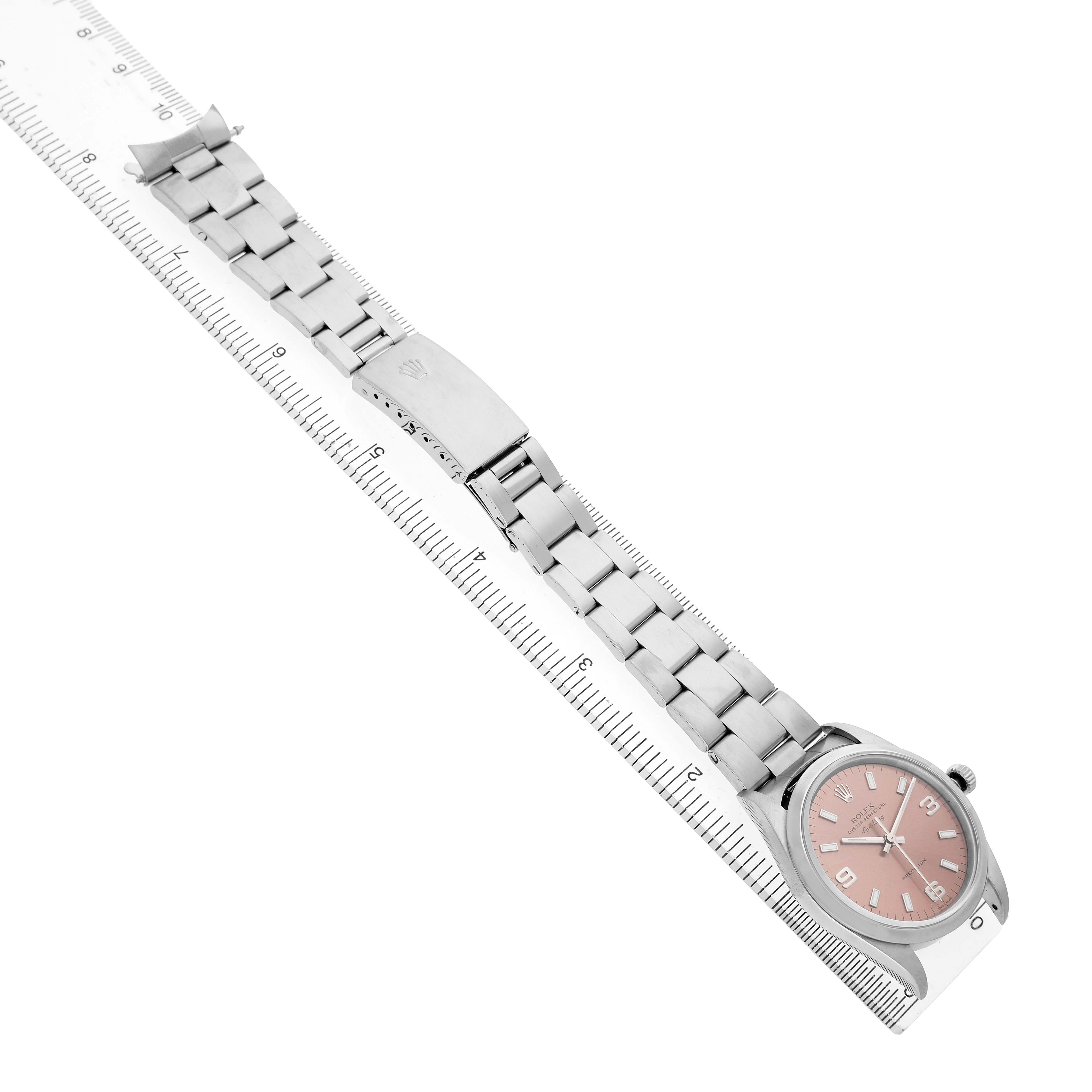 The Rolex Air-King 14000 Men's Stainless Steel Pink Dial watch is shown from a top angle, featuring its bracelet, clasp, and face aligned with a ruler.