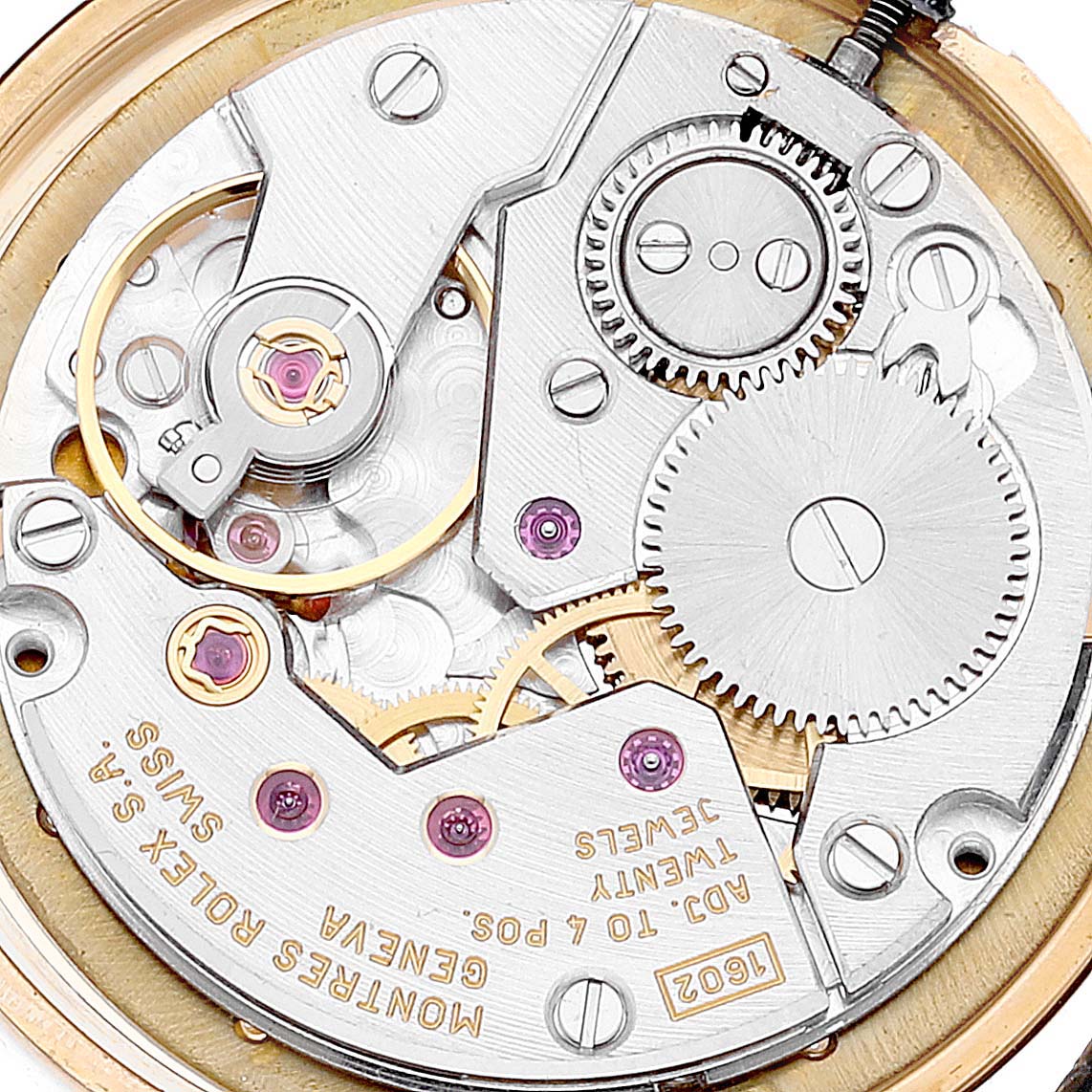 The image shows a close-up of the movement mechanism of a Rolex Cellini 5109 Women's Yellow Gold Mother of Pearl Dial 5109 Women's Yellow Gold Mother of Pearl Dial watch, highlighting gears and intricate parts.