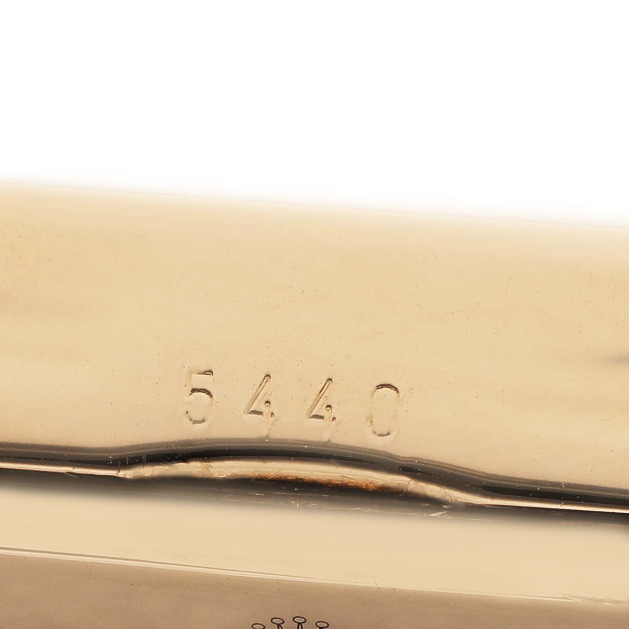The image shows a close-up of a part of the Rolex Cellini 5440 Men's Yellow Gold Champagne Dial watch with the number "5440" engraved.