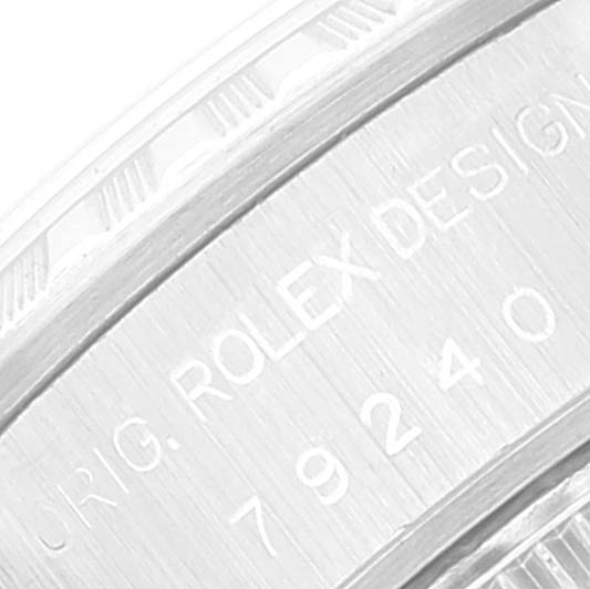 This image shows the engraving on the side of the Rolex Date 79240 Women
s Stainless Steel Blue Dial 79240 Women
s Stainless Steel Blue Dial model watch case at a close angle.