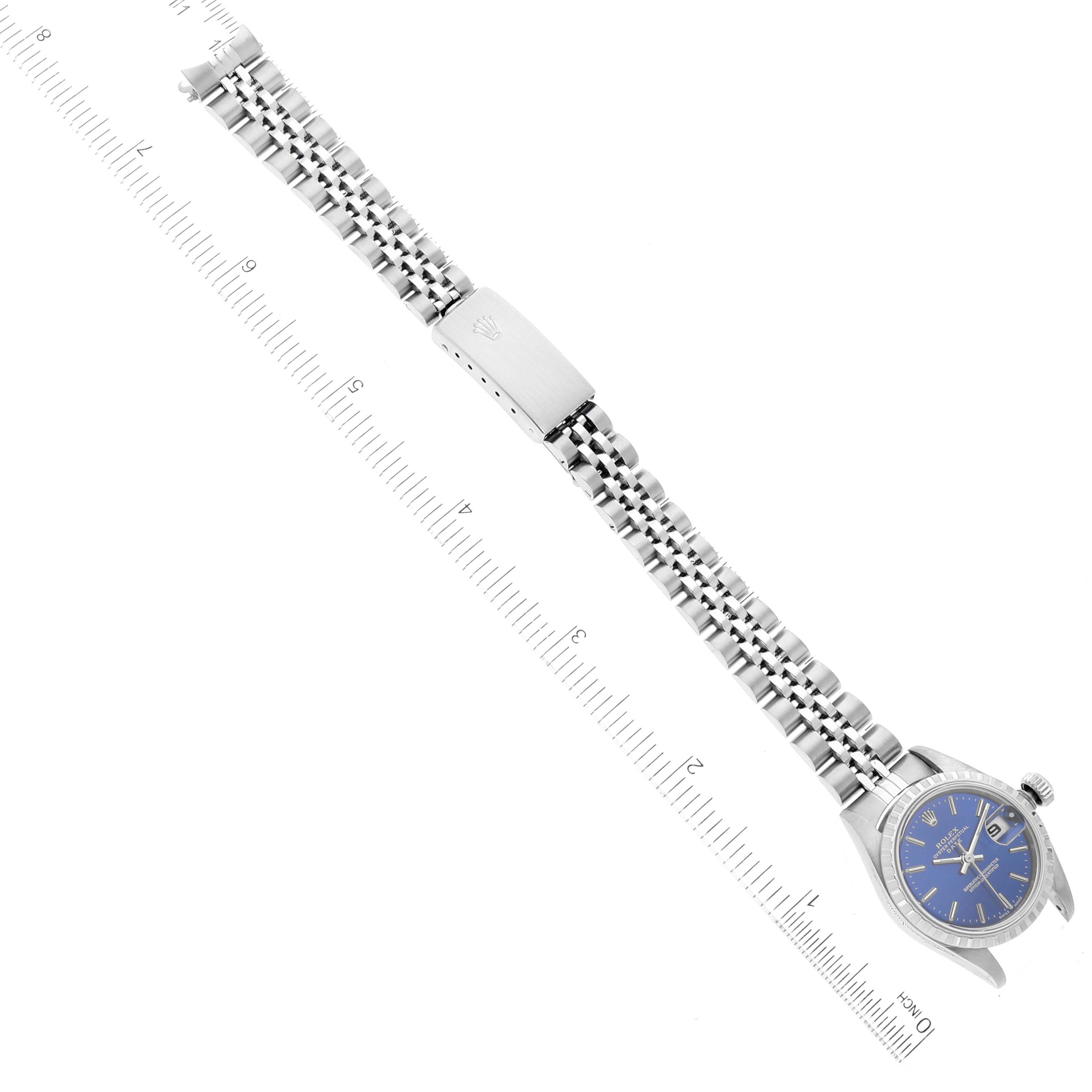 This image shows a Rolex Date 79240 Women
s Stainless Steel Blue Dial 79240 Women
s Stainless Steel Blue Dial model watch laid flat, displaying the face, bracelet, clasp, and a ruler for scale.