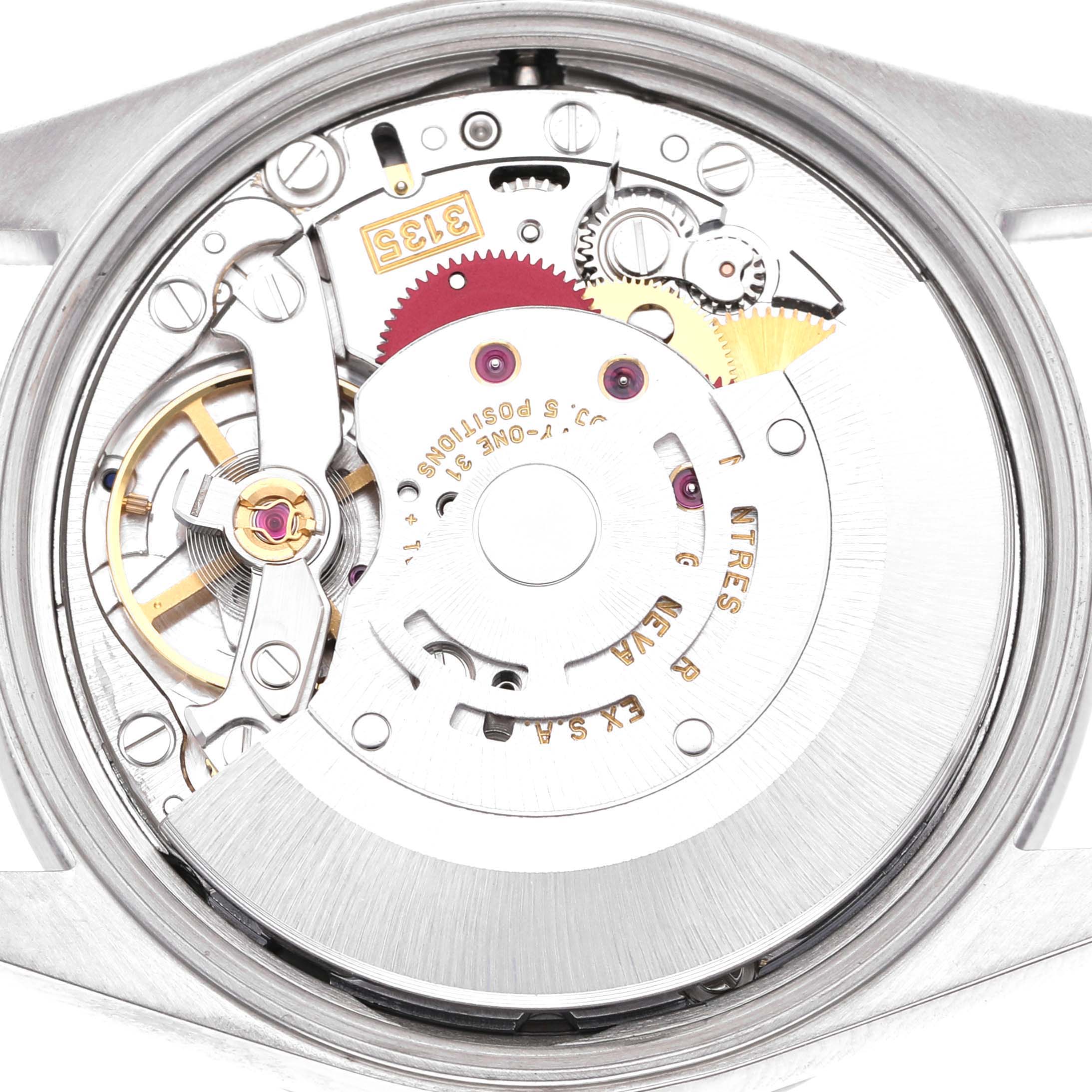 The image shows the movement of a Rolex Date 15210 Men's Stainless Steel White Dial model watch from the rear, highlighting the intricate inner mechanisms.
