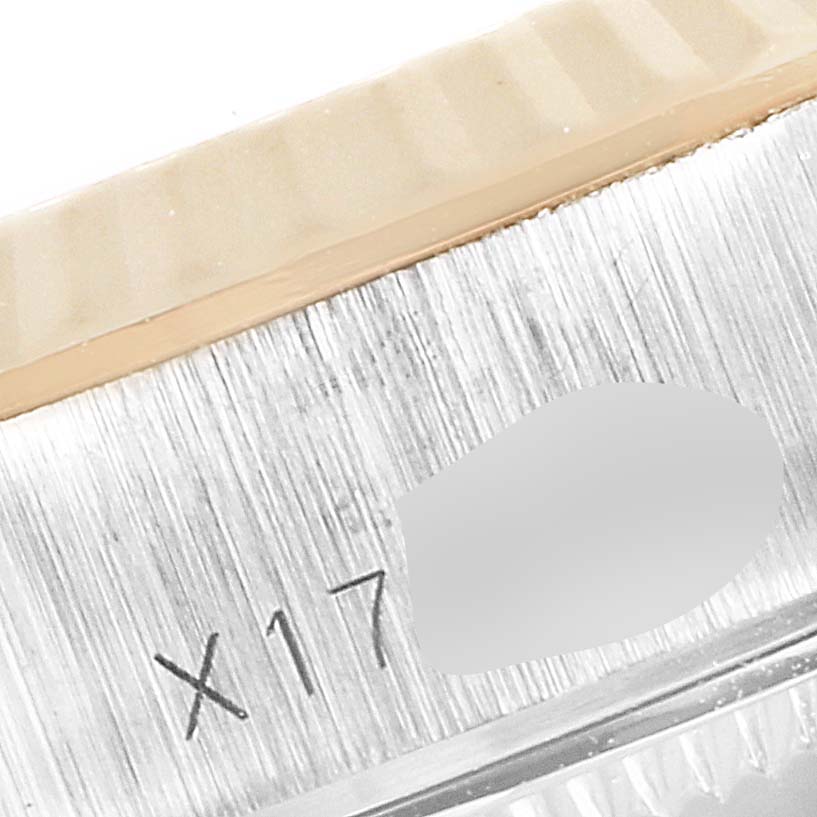 This close-up image shows part of the bezel and case of a Rolex Datejust 69173 Women's Steel and Gold (two tone) Champagne Dial 69173 Women's Steel and Gold (two tone) Champagne Dial watch, revealing the "X17" engraving.