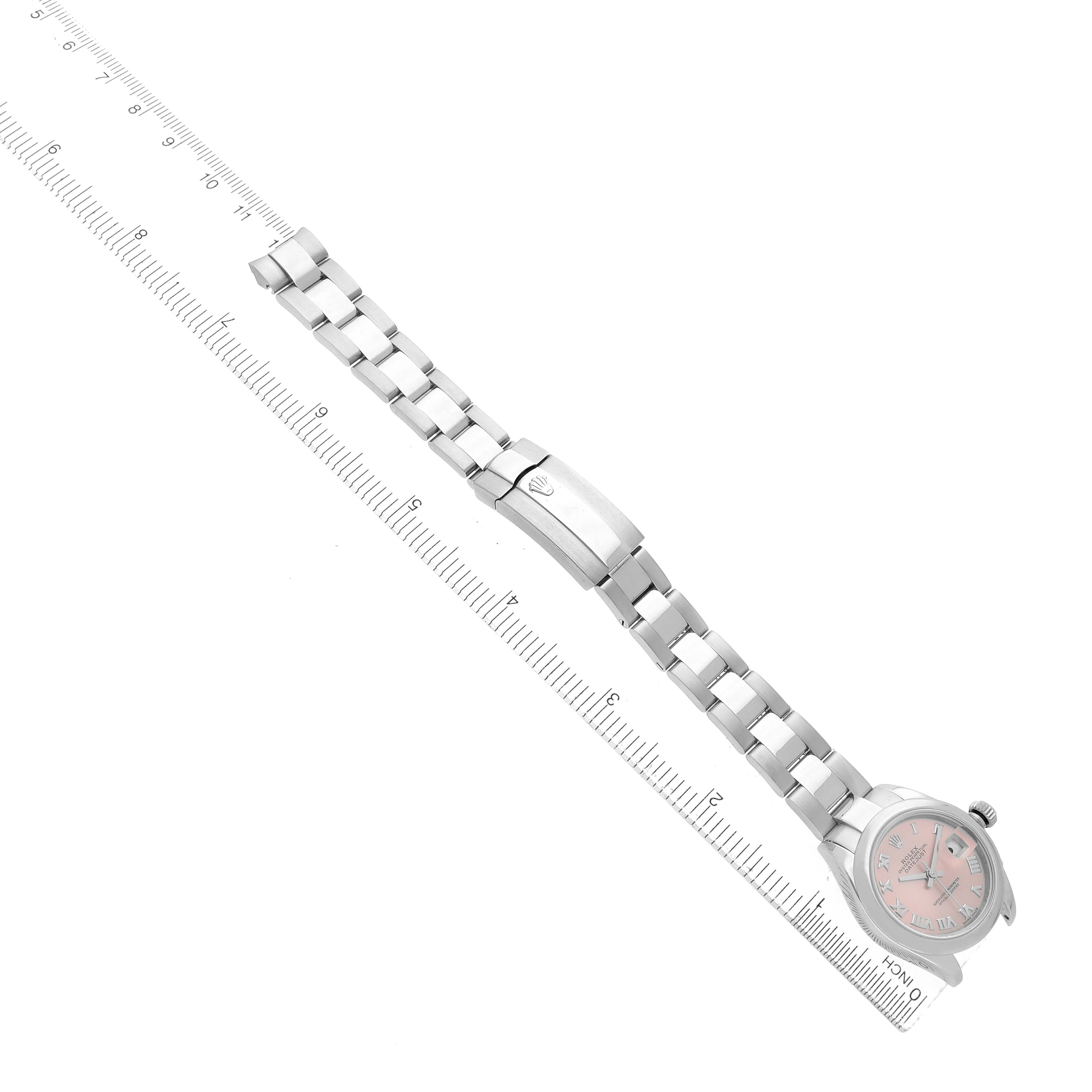 The image shows a Rolex Datejust 279160 Women's Stainless Steel Pink Dial watch laid flat, displaying the bracelet and clasp, alongside a ruler for scale.