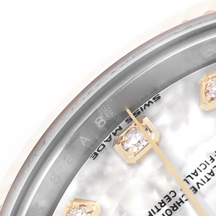 The image shows a close-up of the Rolex Datejust 279173 Women's Steel and Gold (two tone) Mother of Pearl Dial's dial edge, highlighting the "SWISS MADE" text and diamond hour markers.