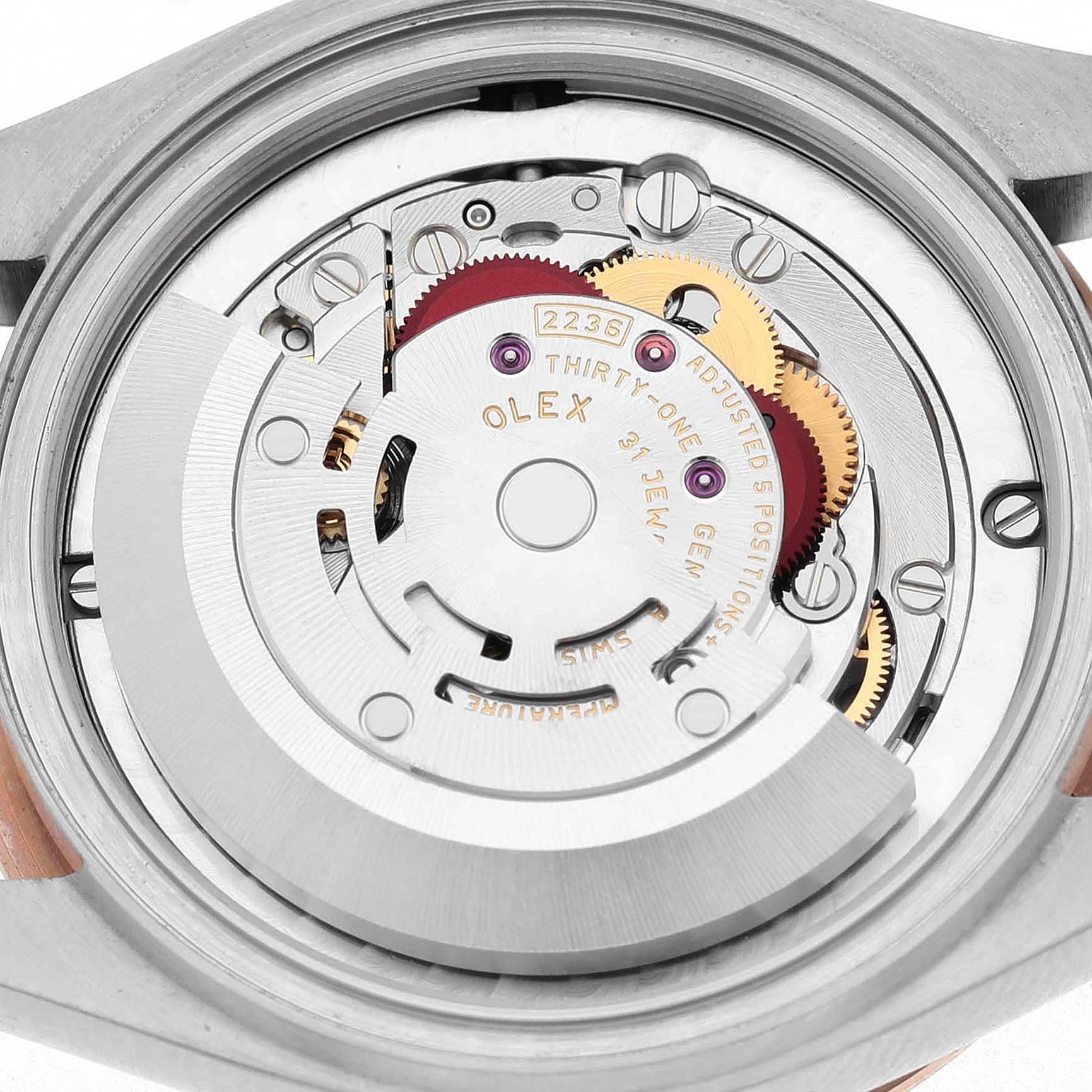 The image shows the movement of a Rolex Datejust 278341 Women's Steel and Gold (two tone) Brown Dial watch from a rear angle, highlighting the gears and mechanical components.