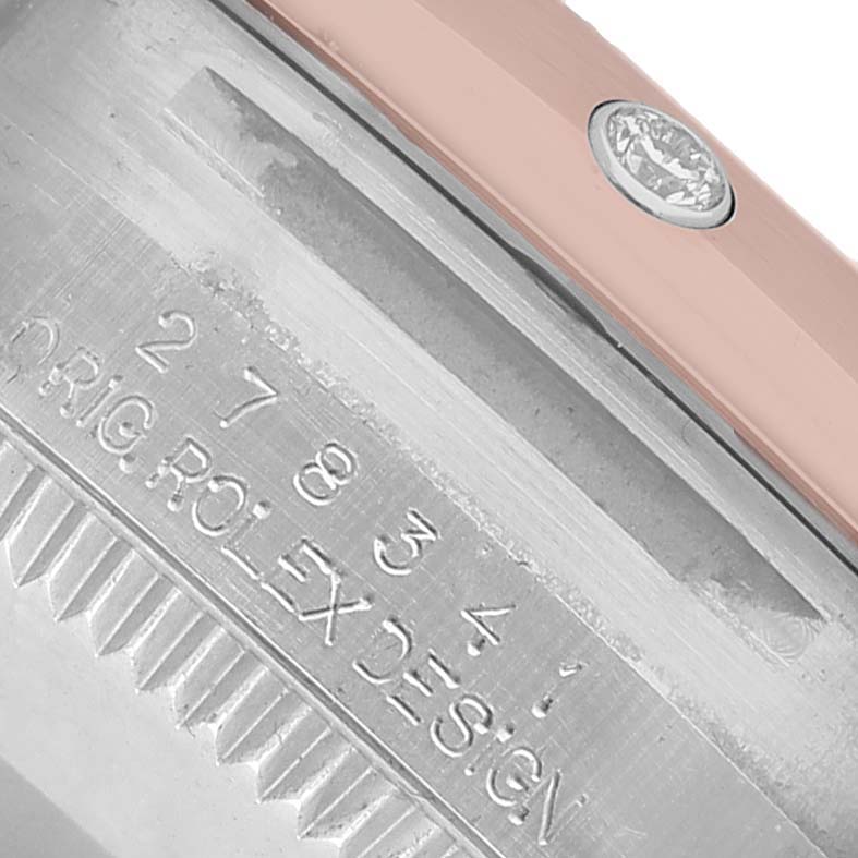 The image shows a close-up of the side engraving and metal edge of a Rolex Datejust 278341 Women's Steel and Gold (two tone) Brown Dial watch with a diamond detail.