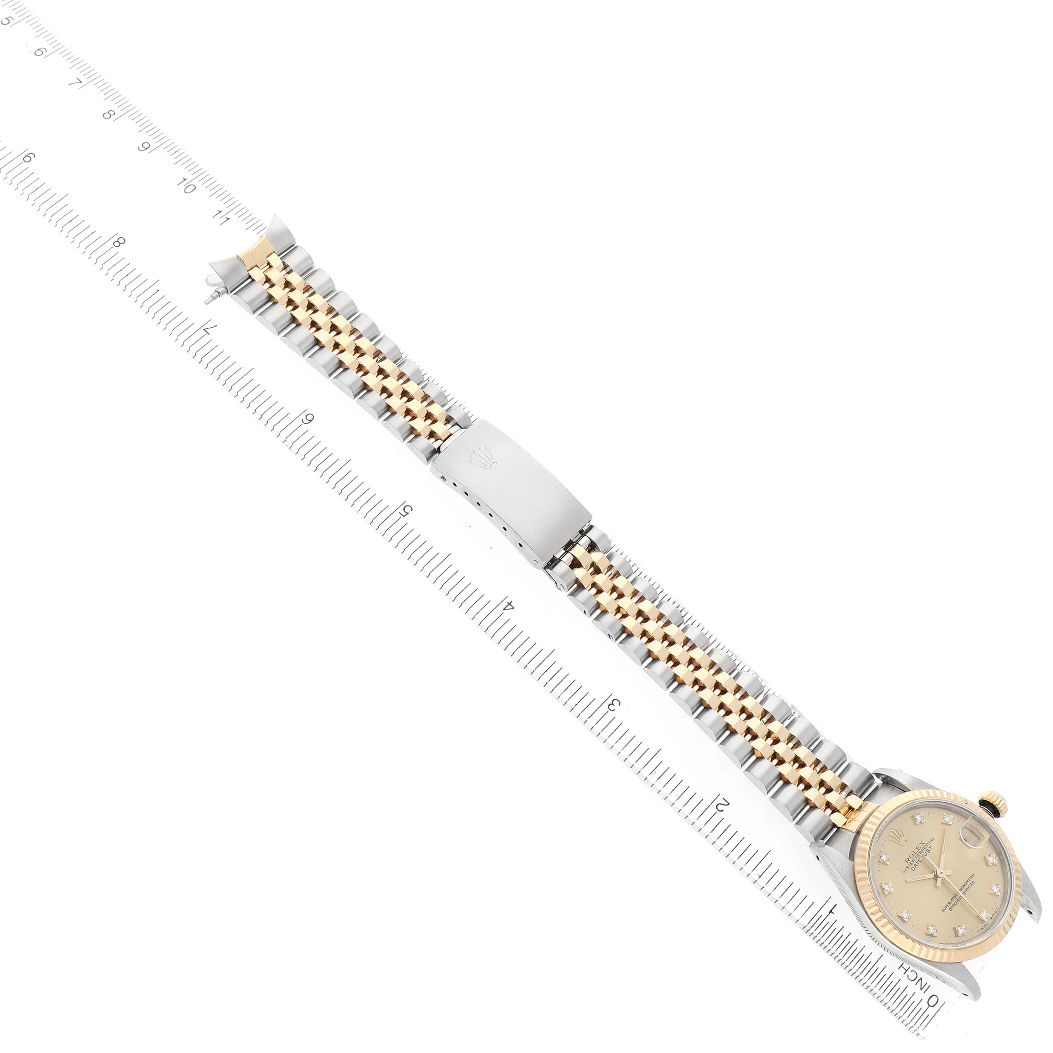 The Rolex Datejust 68273 Women's Steel and Gold (two tone) Champagne Dial watch is shown at a diagonal angle, displaying the gold and silver bracelet, crown, and round face with markers.