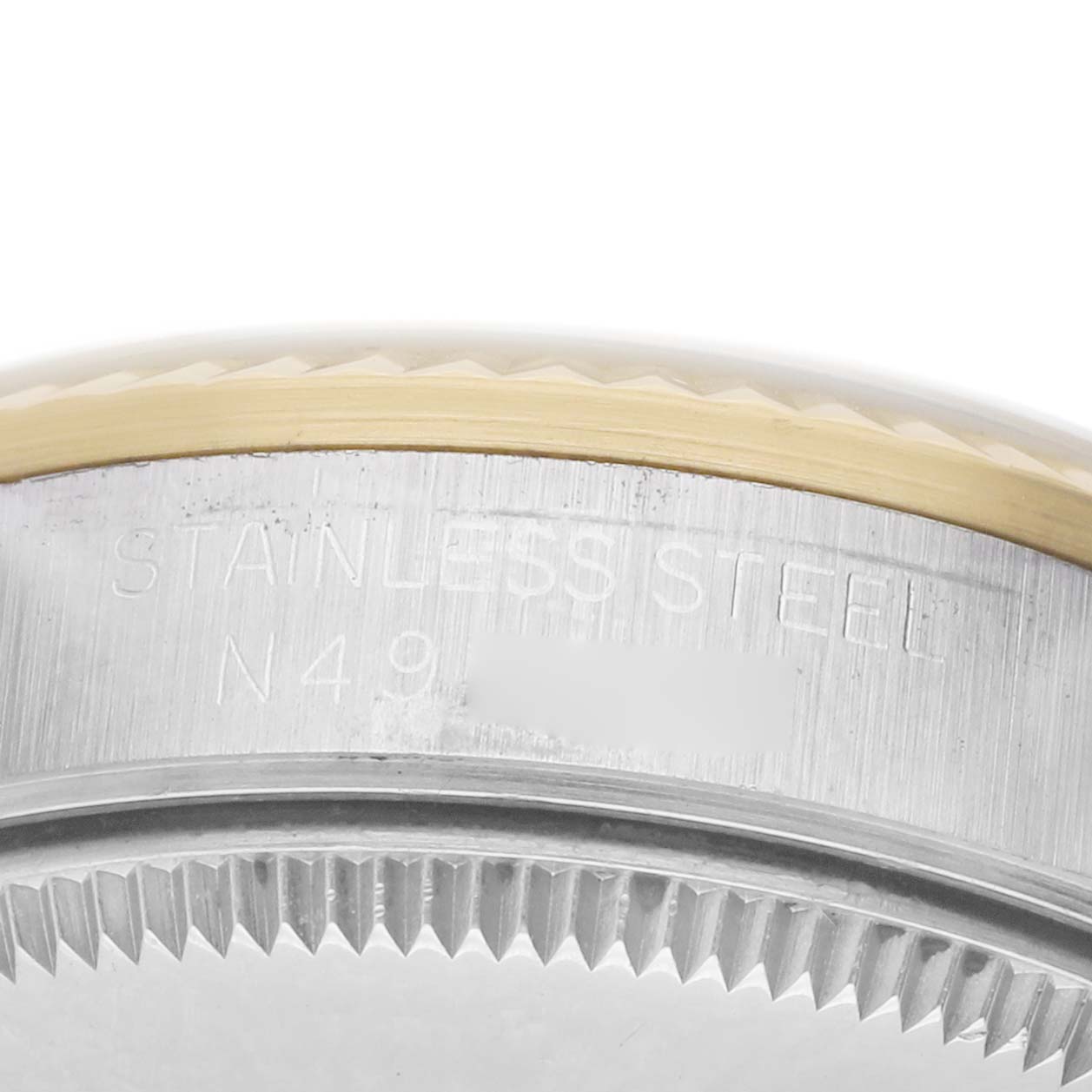 The image shows a close-up of the side and bezel area of a Rolex Datejust 68273 Women's Steel and Gold (two tone) Champagne Dial, highlighting the stainless steel engravings.