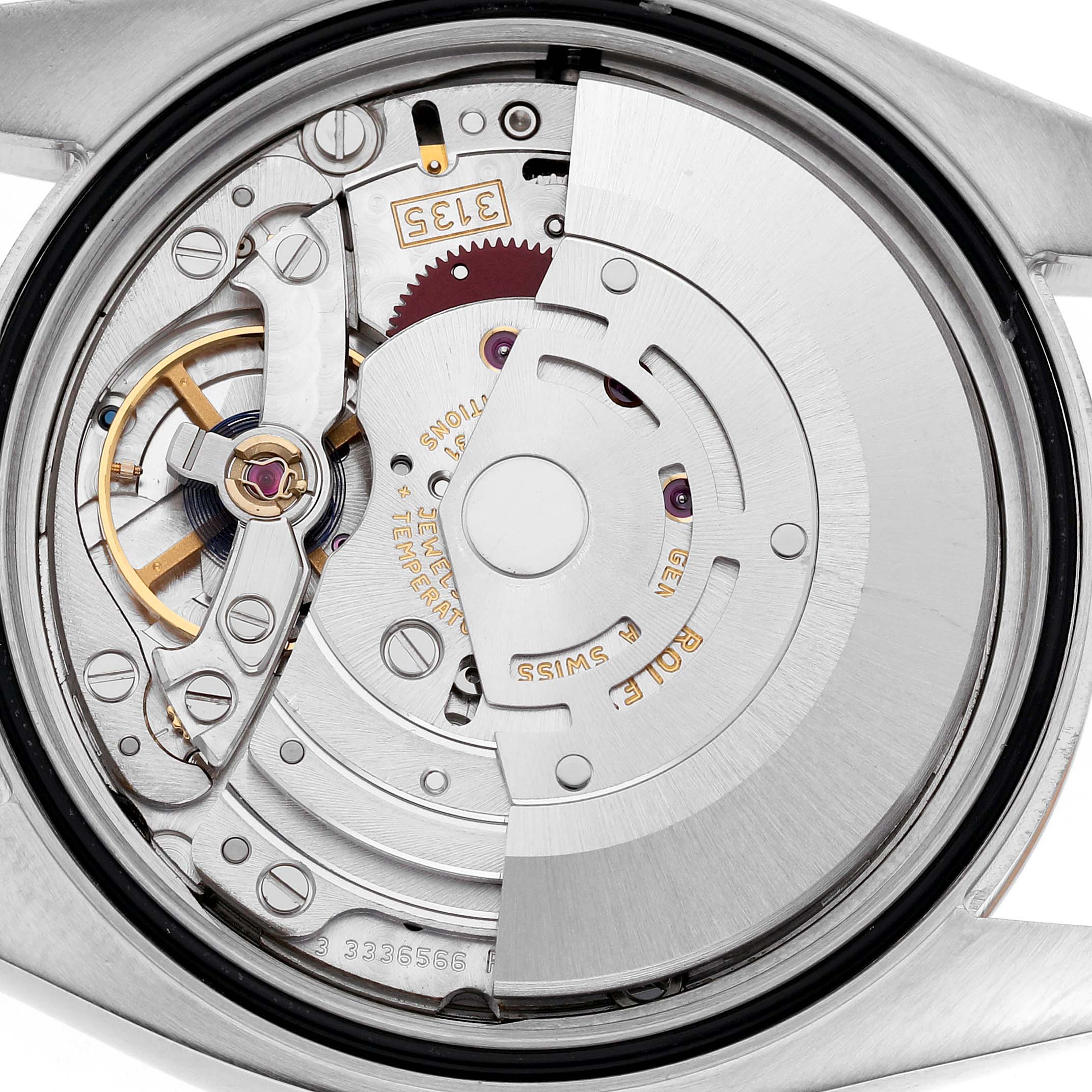 The image shows the Rolex Datejust 116231 Men's Steel and Gold (two tone) Silver Dial movement from the back, highlighting the rotor, balance wheel, and caliber 3135.